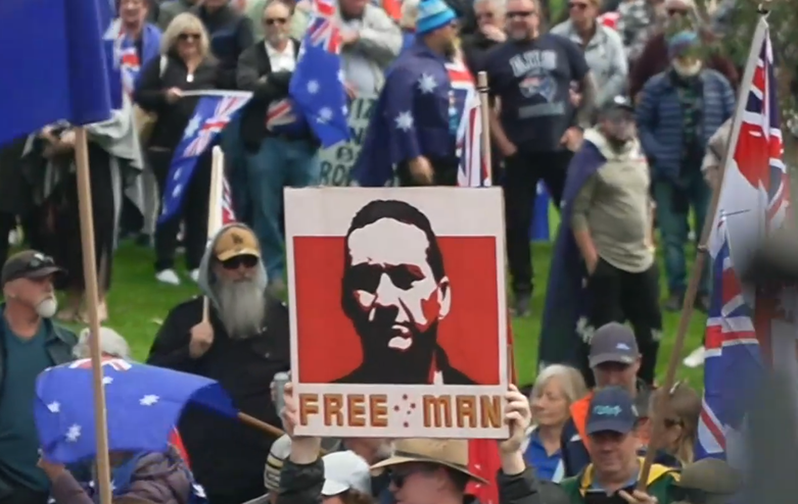 Man charged after Dezi Freeman sign displayed at rally