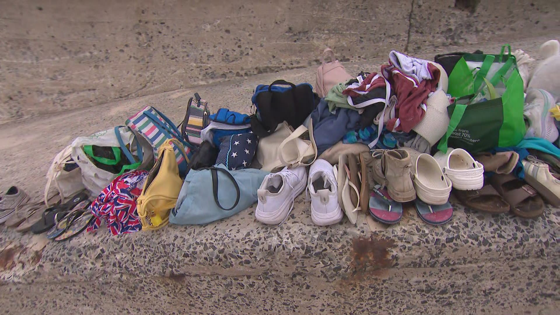 Personal belongings have been left scattered across Bondi Beach, with shoes, bags, children's toys, books and towels still lining the sand after people left them behind to run for their lives.