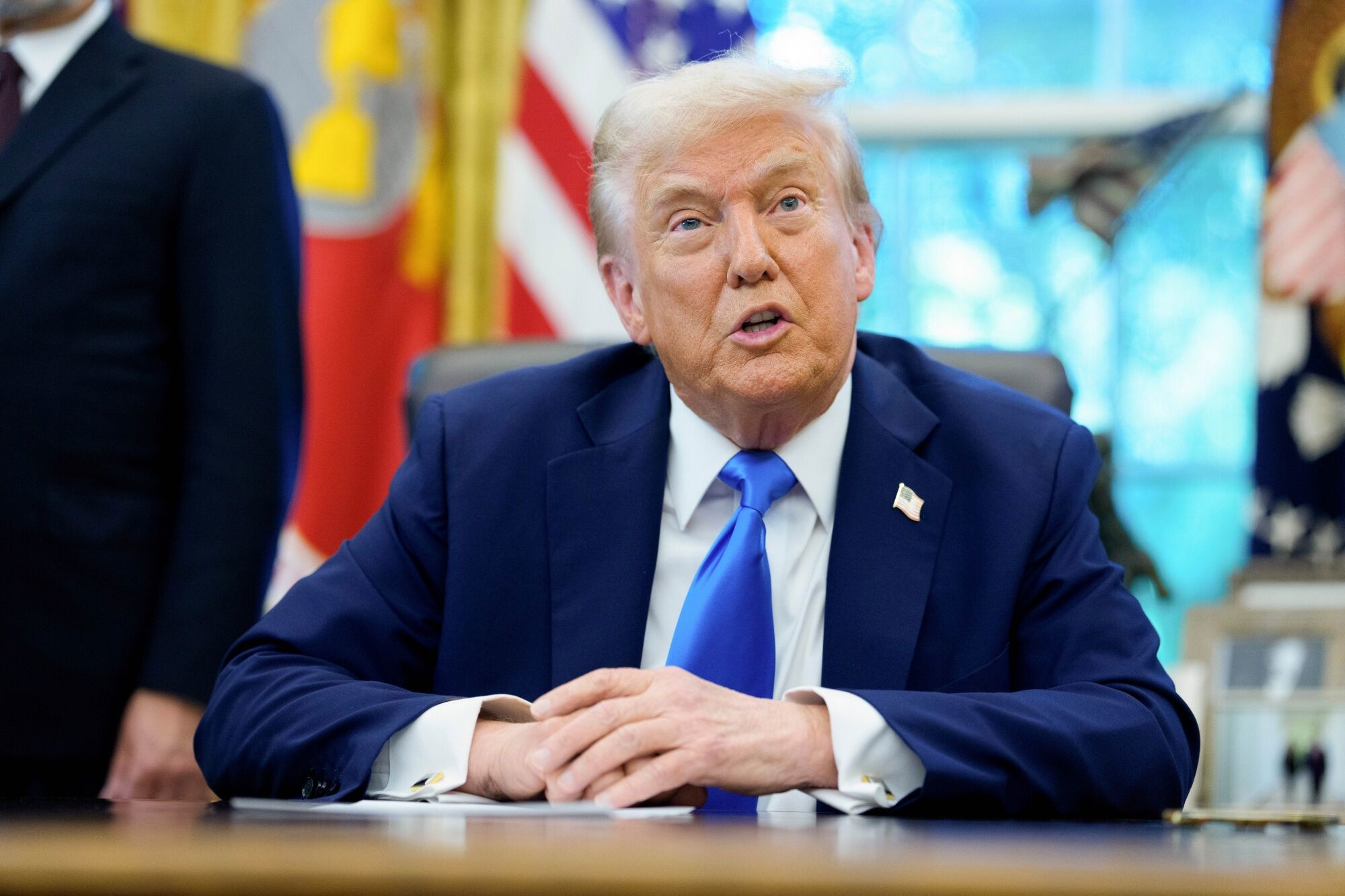 US President Donald Trump speaks to members of the media in the Oval Office of the White House in Washington, DC, US, on Friday, Sept. 19, 2025. Trump is signing a proclamation that would move to extensively overhaul the H-1B visa program, requiring a $100,000 fee for applications in a bid to curb overuse, according to a White House official familiar with the matter. Photographer: Aaron Schwartz/CNP/Bloomberg