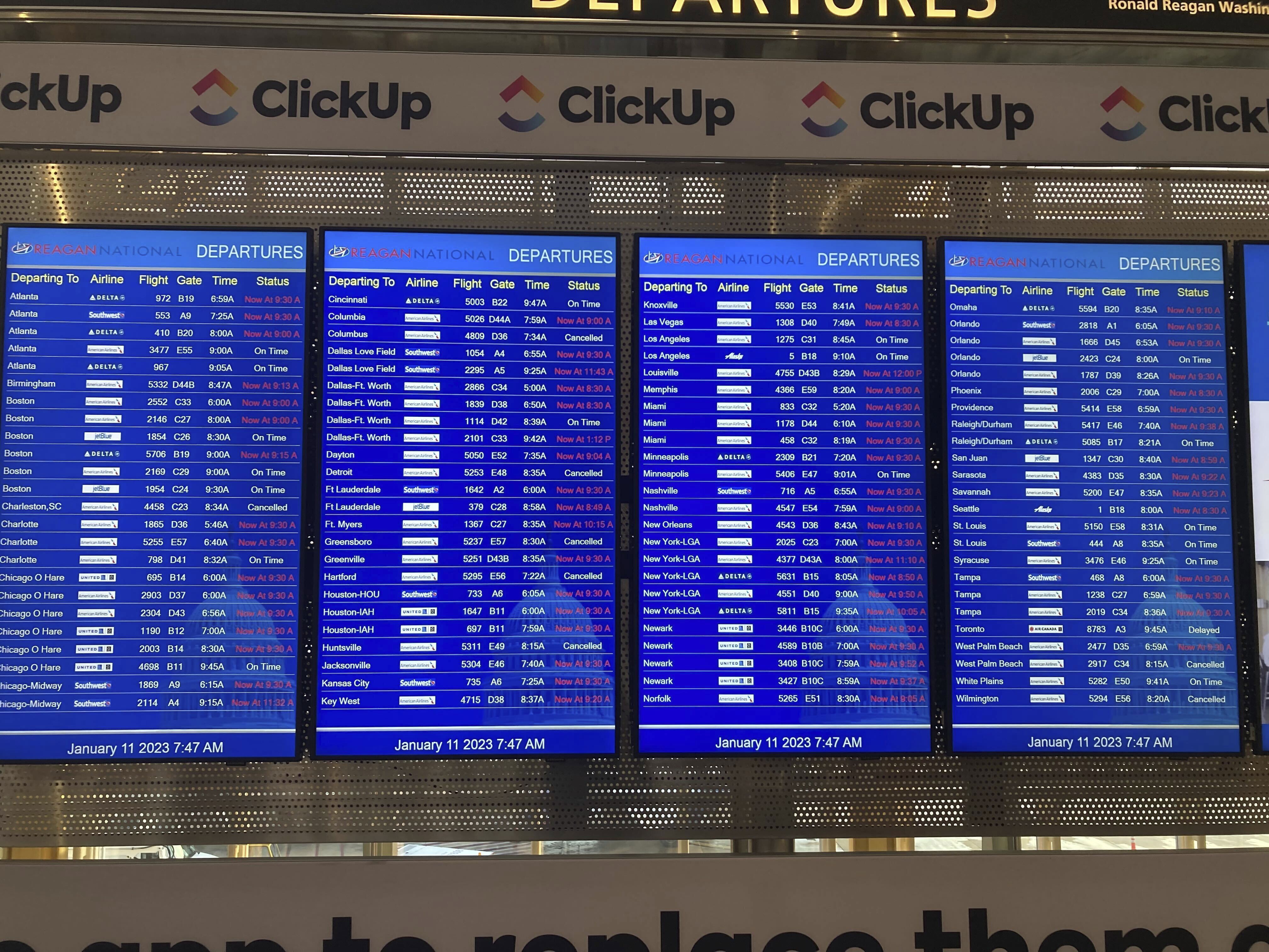 A message board shows departures at Ronald Reagan Washington National Airport in Arlington, Va., on Wednesday, Jan. 11. 2023.  