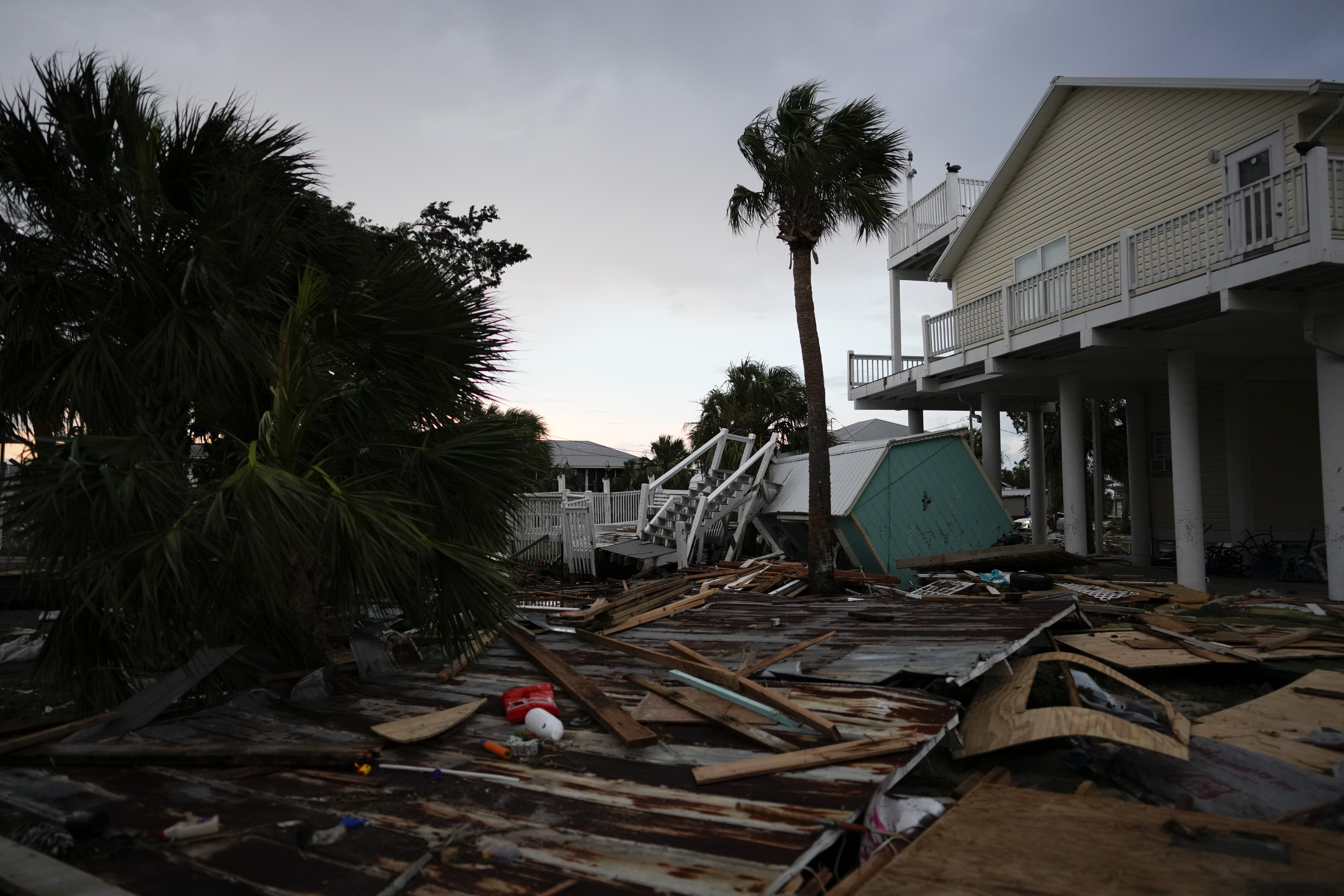 Debris from destroyed buildings lies next to a home still standing in Horseshoe Beach, Fla., after the passage of Hurricane Idalia, Wednesday, Aug. 30, 2023. 