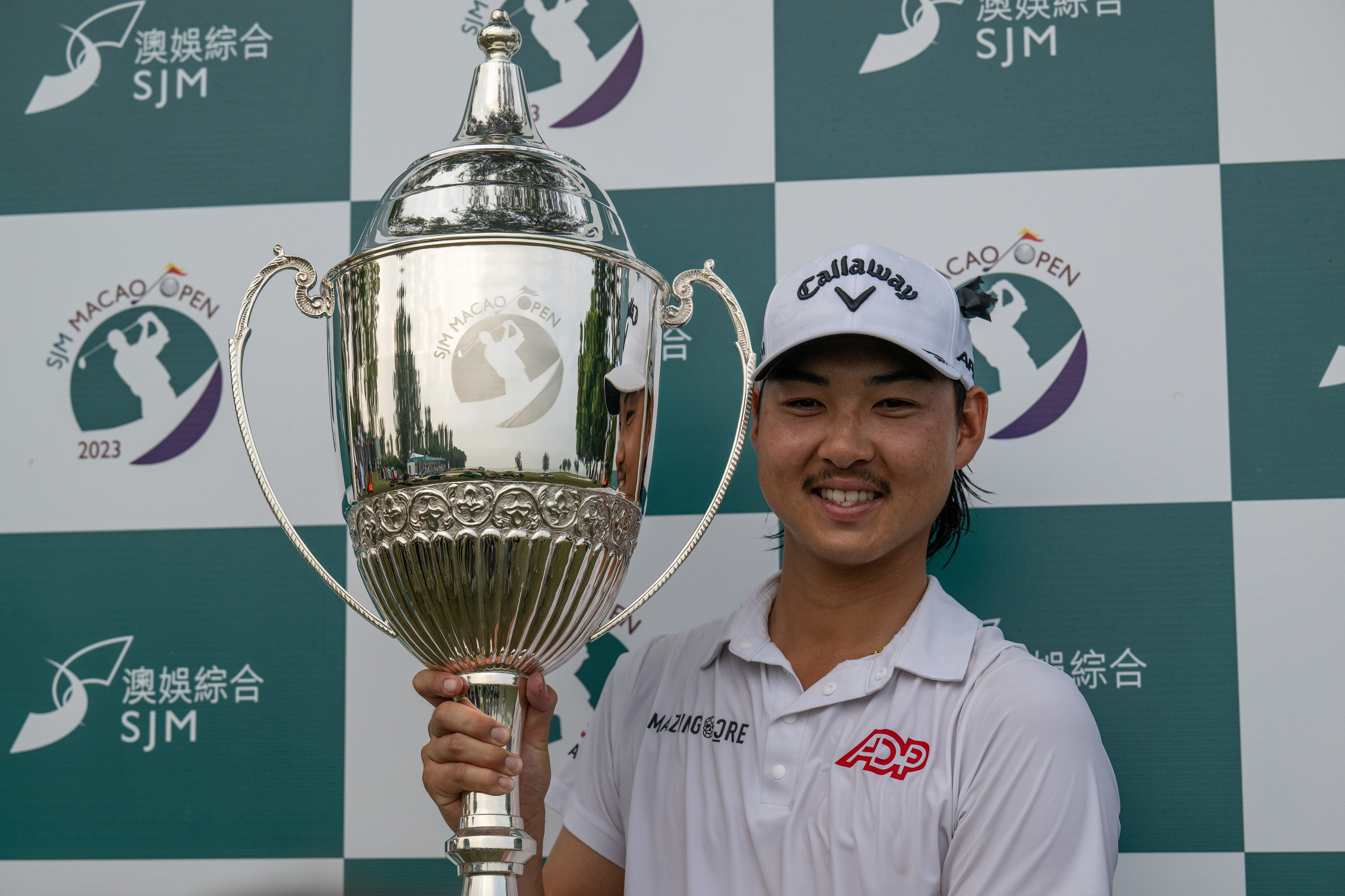 Australia's Min Woo Lee poses with the winner's trophy after triumphing at the Macau Open.
