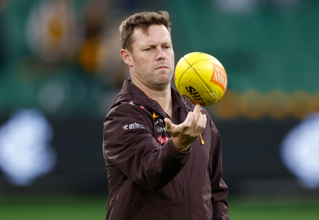 Sam Mitchell, Senior Coach of the Hawks looks on.