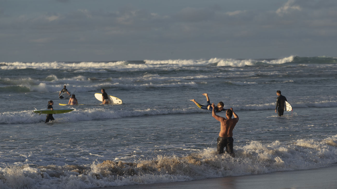 Swimmers and surfers are pictured at Wategos Beach in Byron Bay.