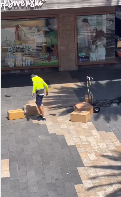 A﻿n Australia Post employee has come under fire after he was filmed hurling delivery boxes outside a retail store. 