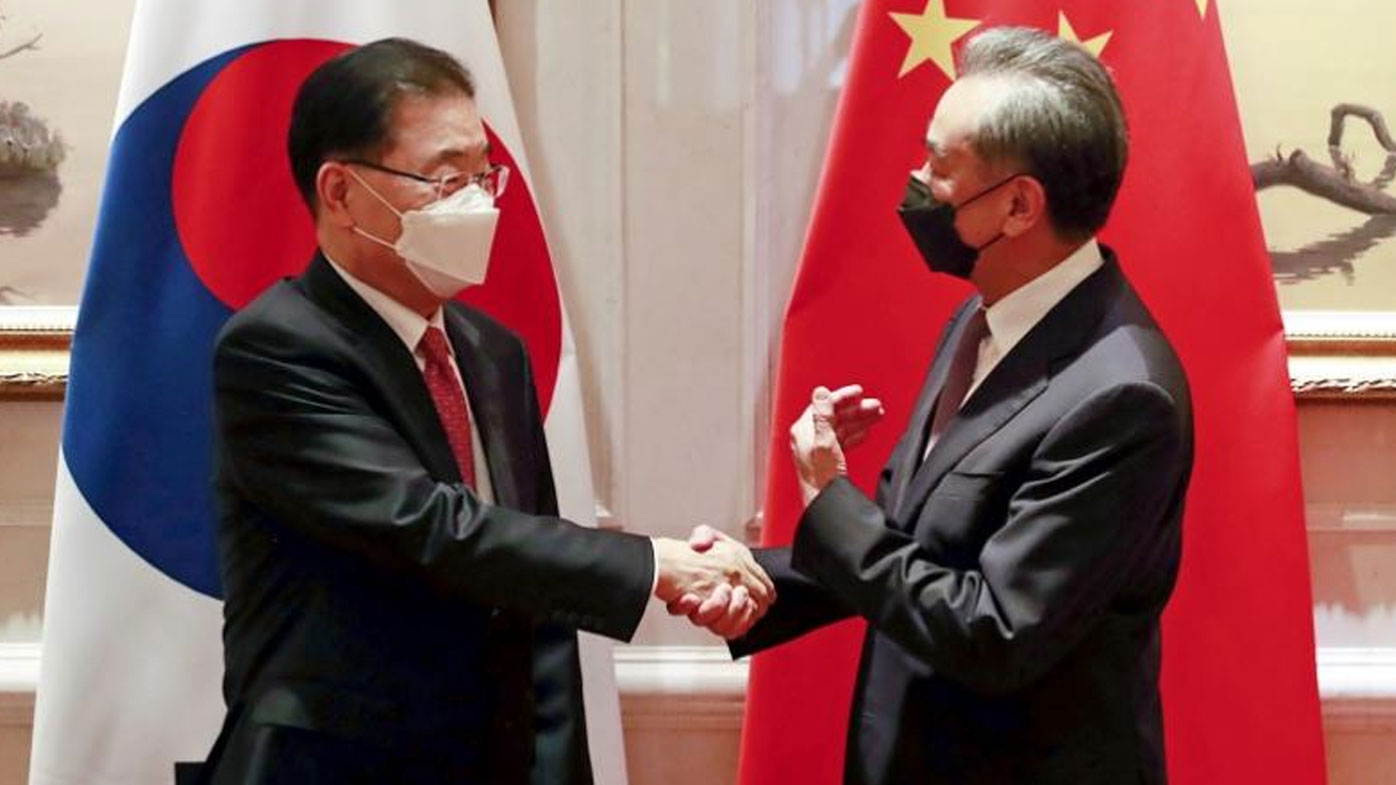 South Korean Foreign Minister Chung Eui-yong, left, shakes hands with Chinese Foreign Minister Wang Yi before their meeting in Xiamen, China, Saturday, April 3, 2021