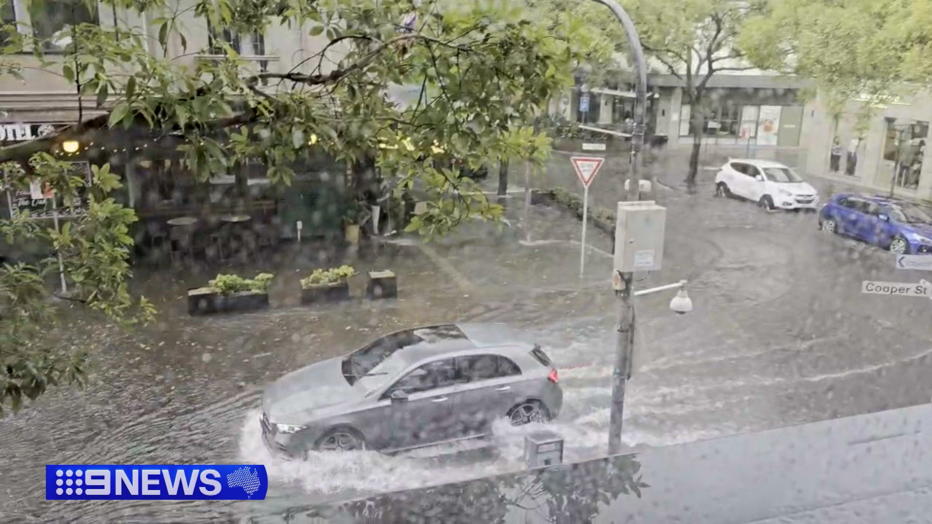 A flash of heavy rain forced planes to divert, streets to flood and ceilings to collapse in Sydney.
