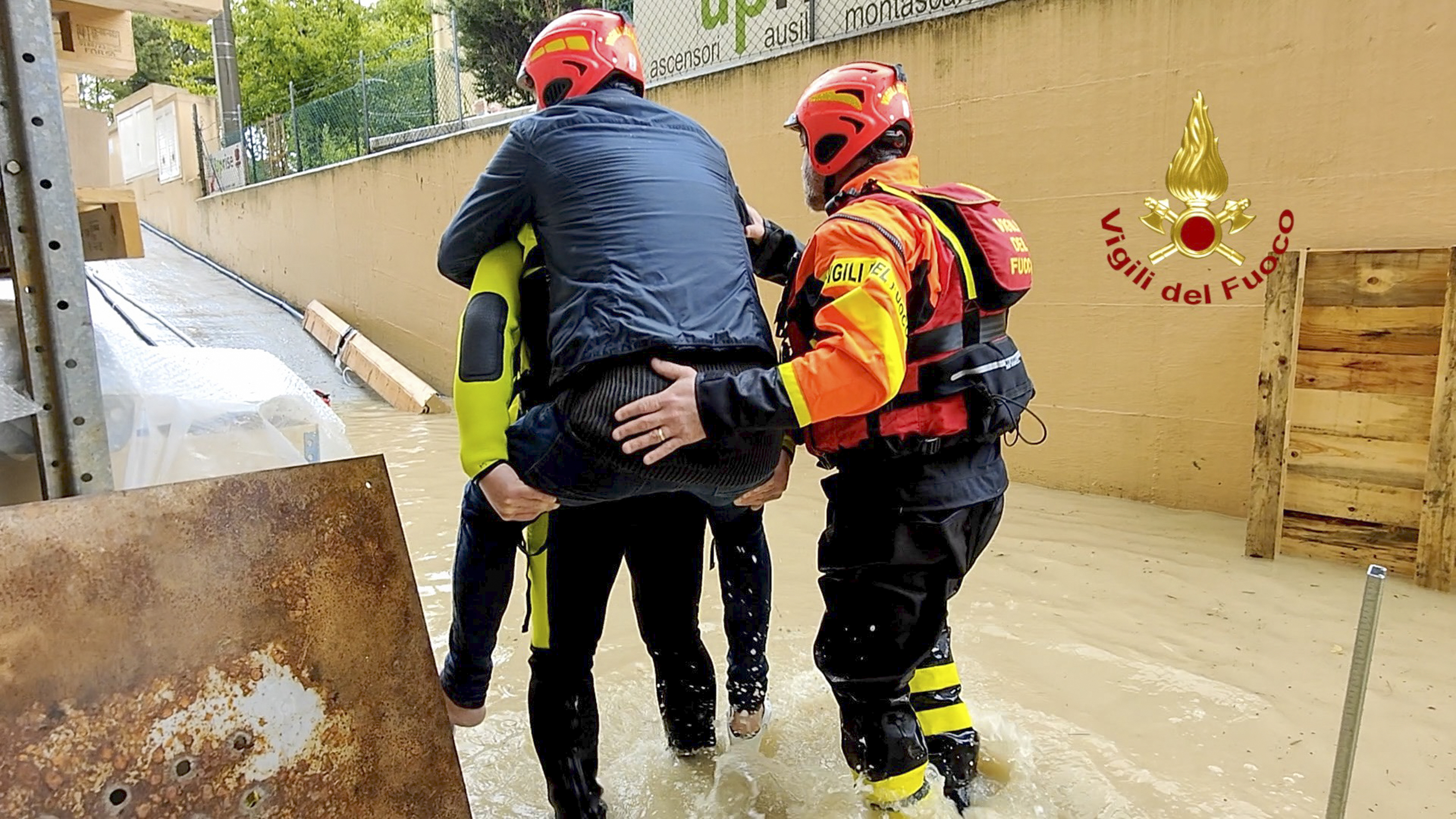 Italian Firefighters rescue a person from a flooded house in Riccione, in the northern Italian region of Emilia Romagna, Tuesday, May 16, 2023.