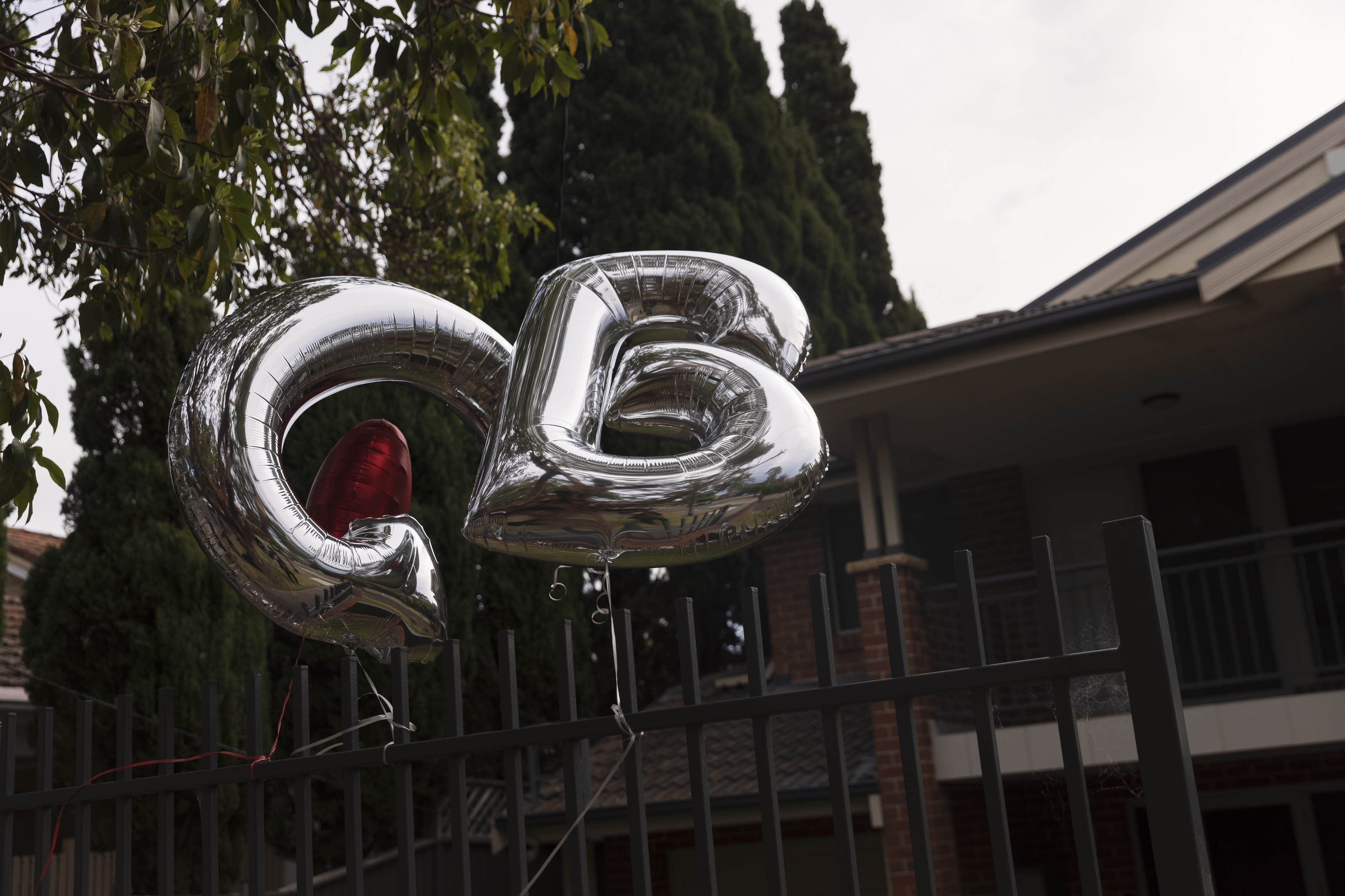 Balloons are tied to the front gate of Gladys Berejiklian's Sydney home today after her shock resignation.