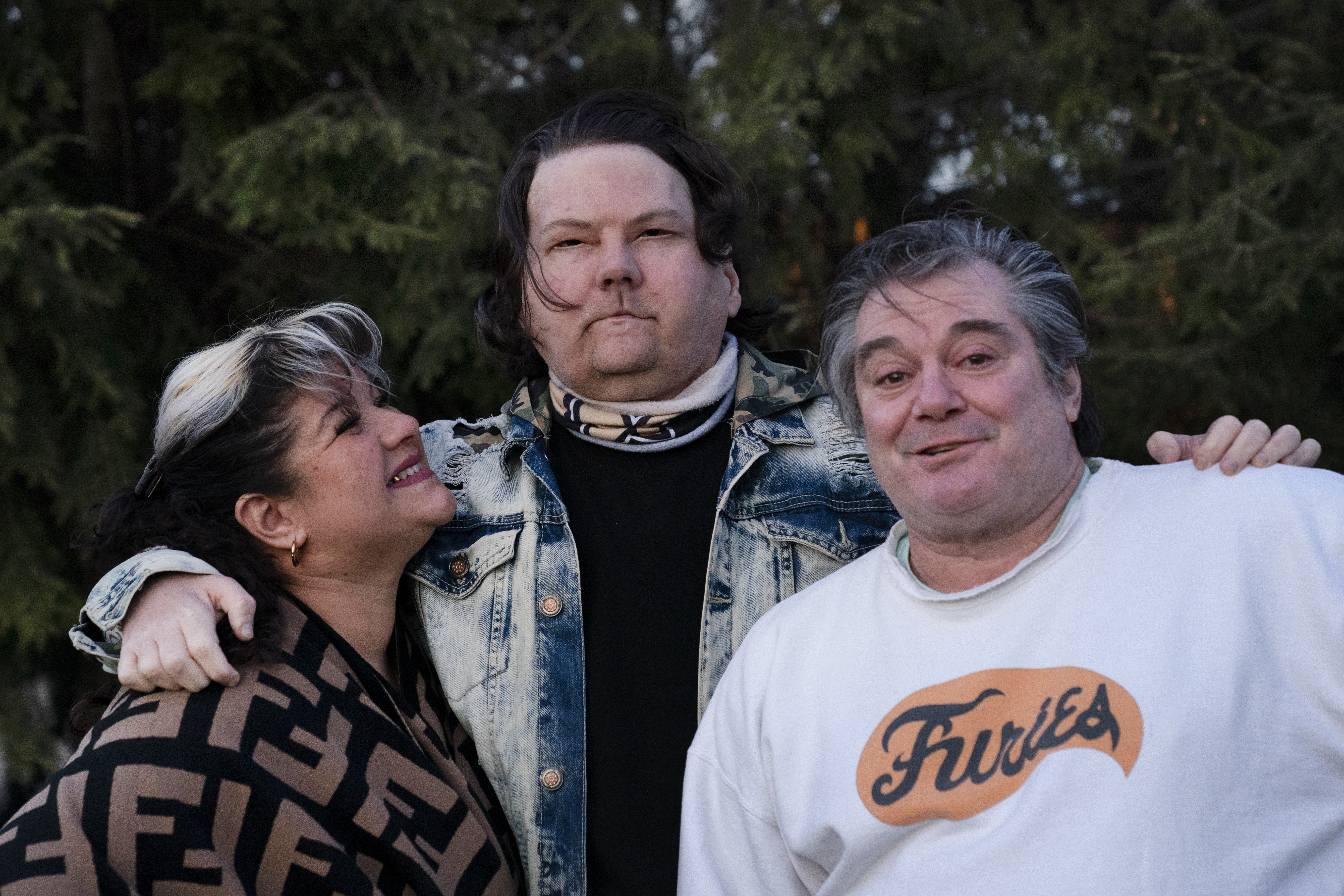 Joe DiMeo stands with his parents Rose and John in the backyard of their home in Clark, N.J. (AP Photo/Mark Lennihan)