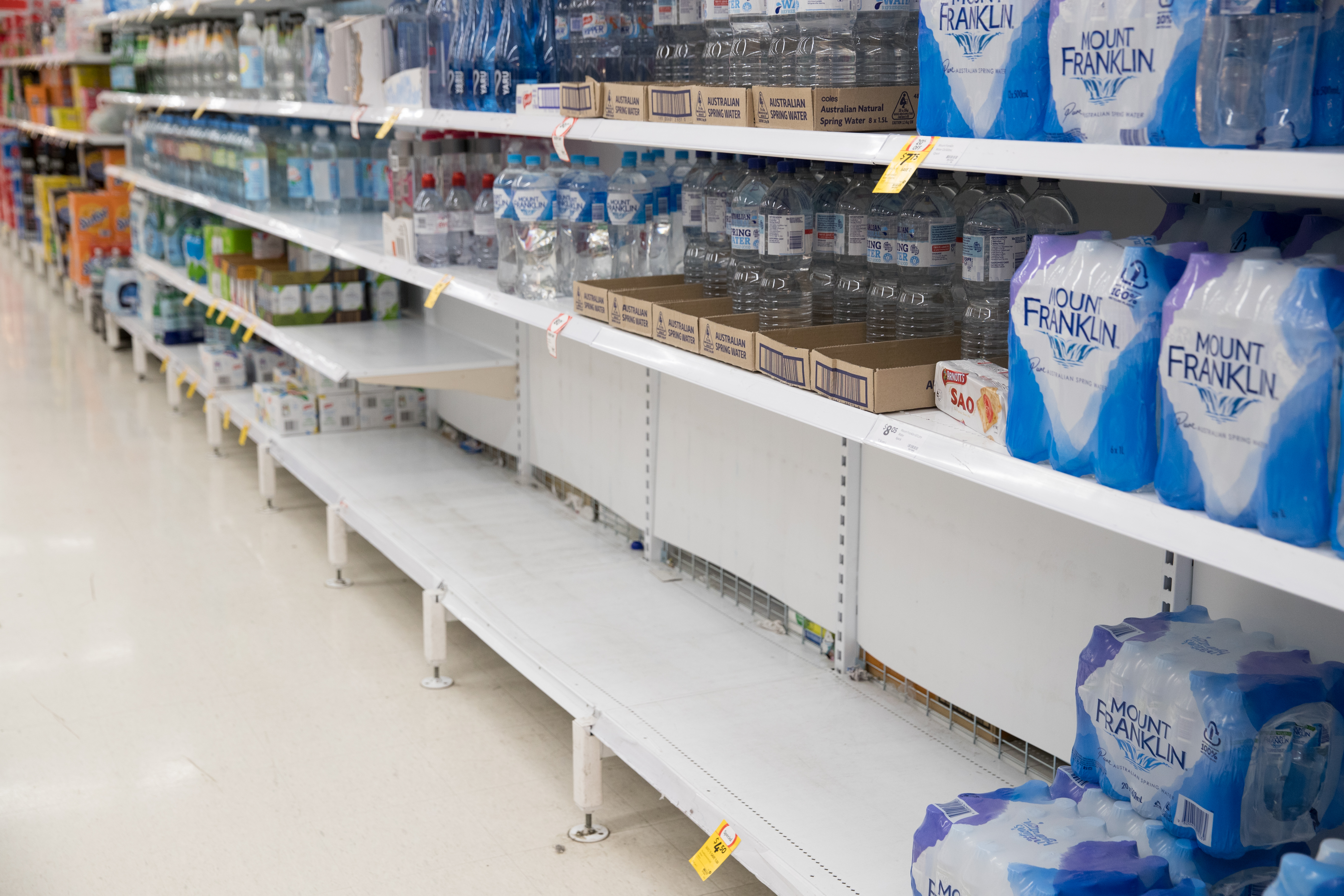 Empty shelves where boxes of water would normally be, in Coles Supermarket, Woy Woy. 