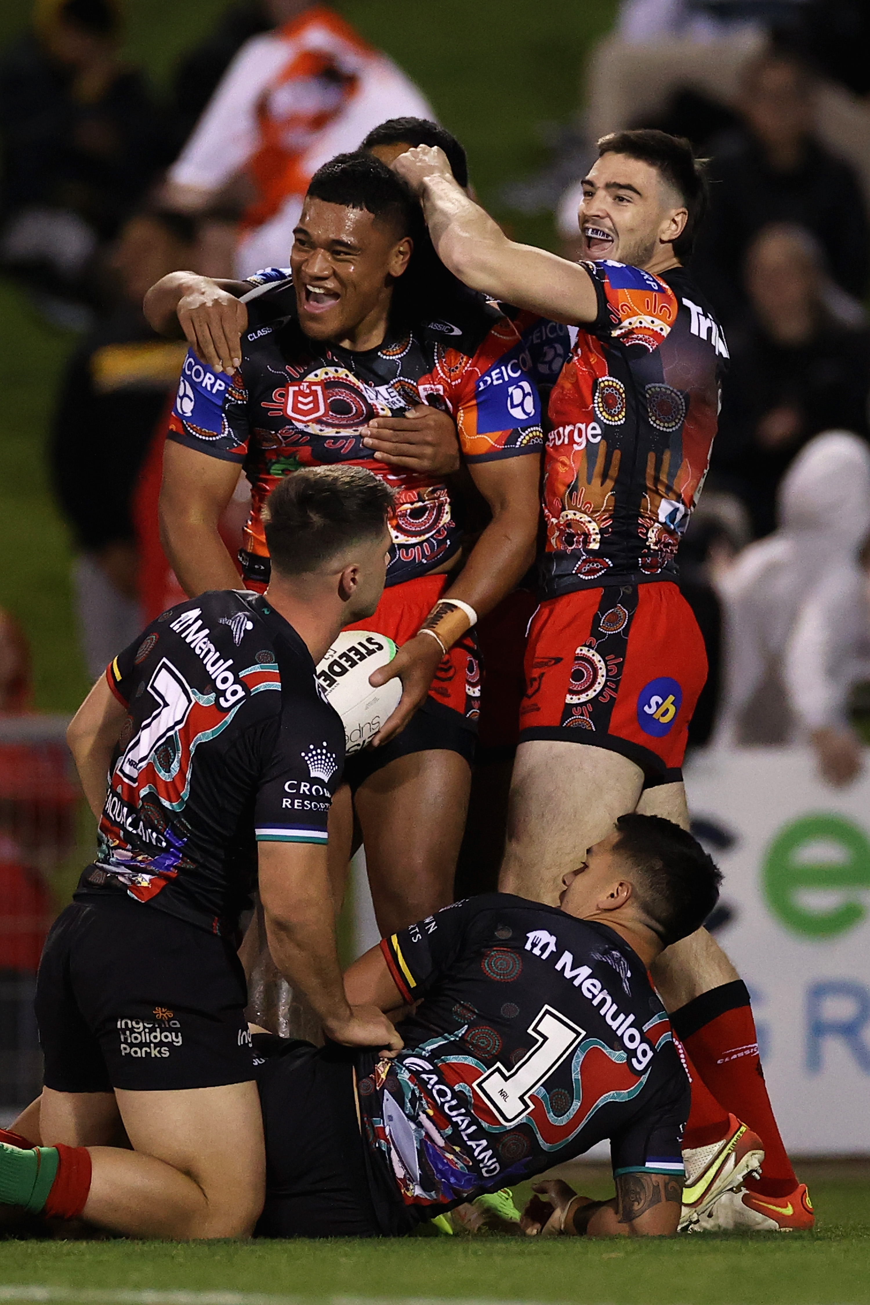 Moses Suli of the Dragons celebrates scoring a try.