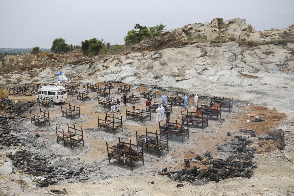 Bodies of people who died of COVID-19 are cremated at an open crematorium on the outskirts of Bengaluru, Karnataka state, India. 