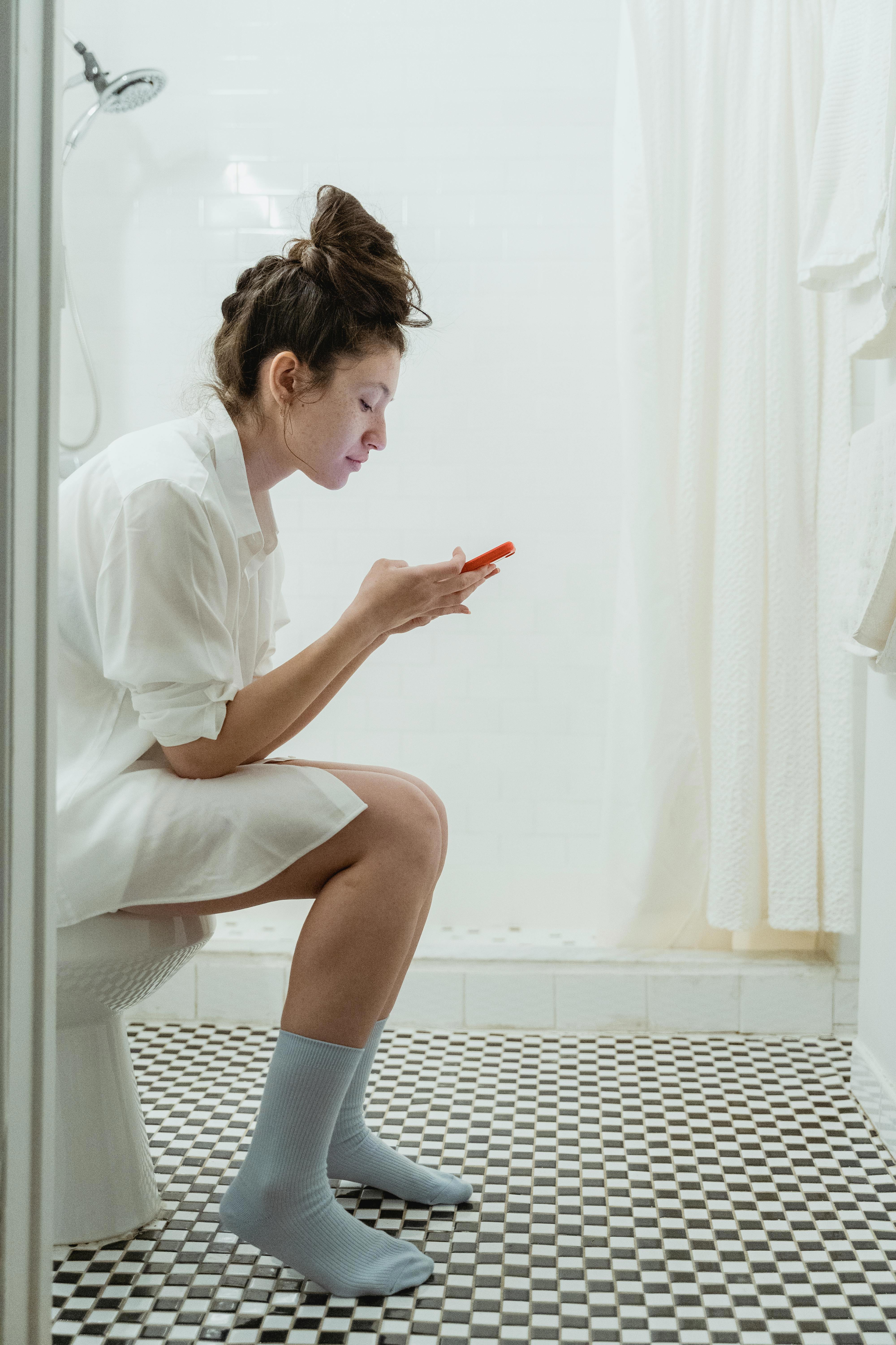 Stock photo of a woman on the toilet.