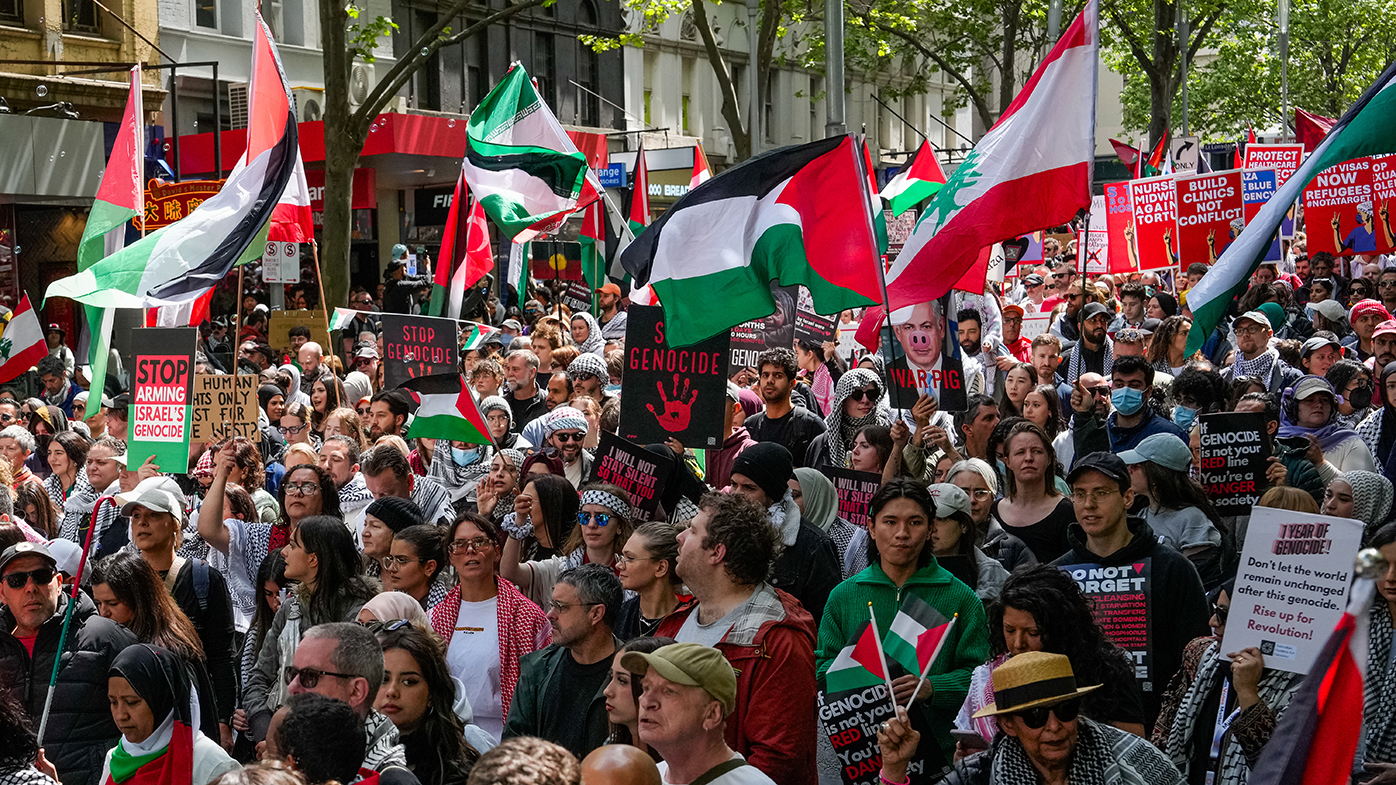 Protesters march down Swanston Street in Melbourne.