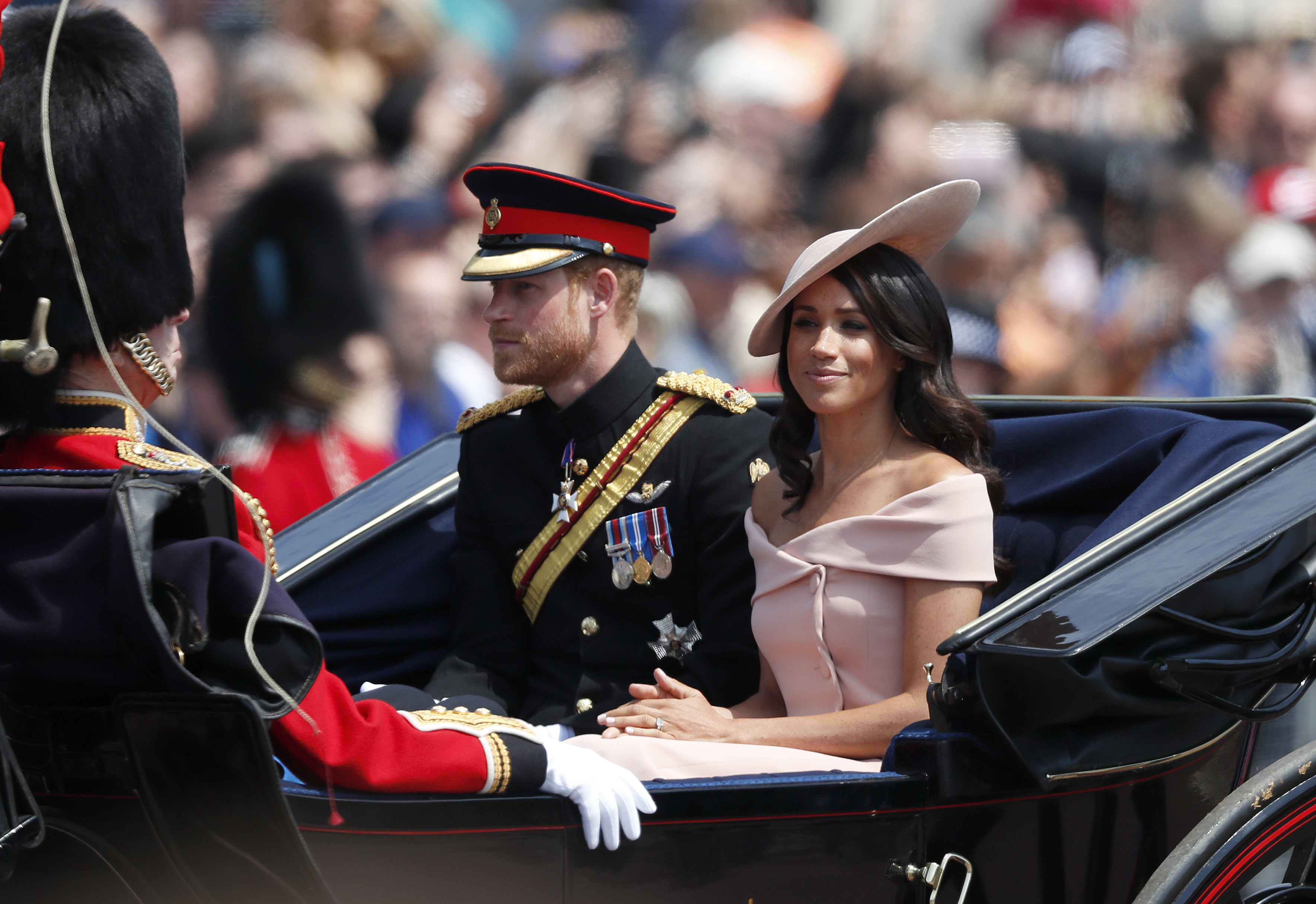 Britain's Prince Harry, left, and Meghan, Duchess of Sussex ride in a carriage to attend the annual Trooping the Colour Ceremony in London, Saturday, June 9, 2018.(AP Photo/Frank Augstein)