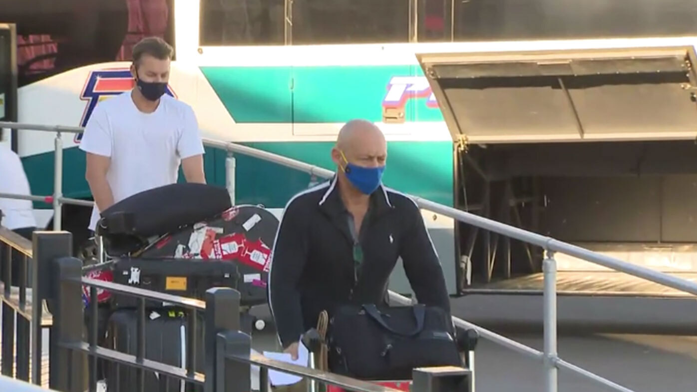 Aussie cricketers exit Sydney airport, bound for quarantine after leaving India.