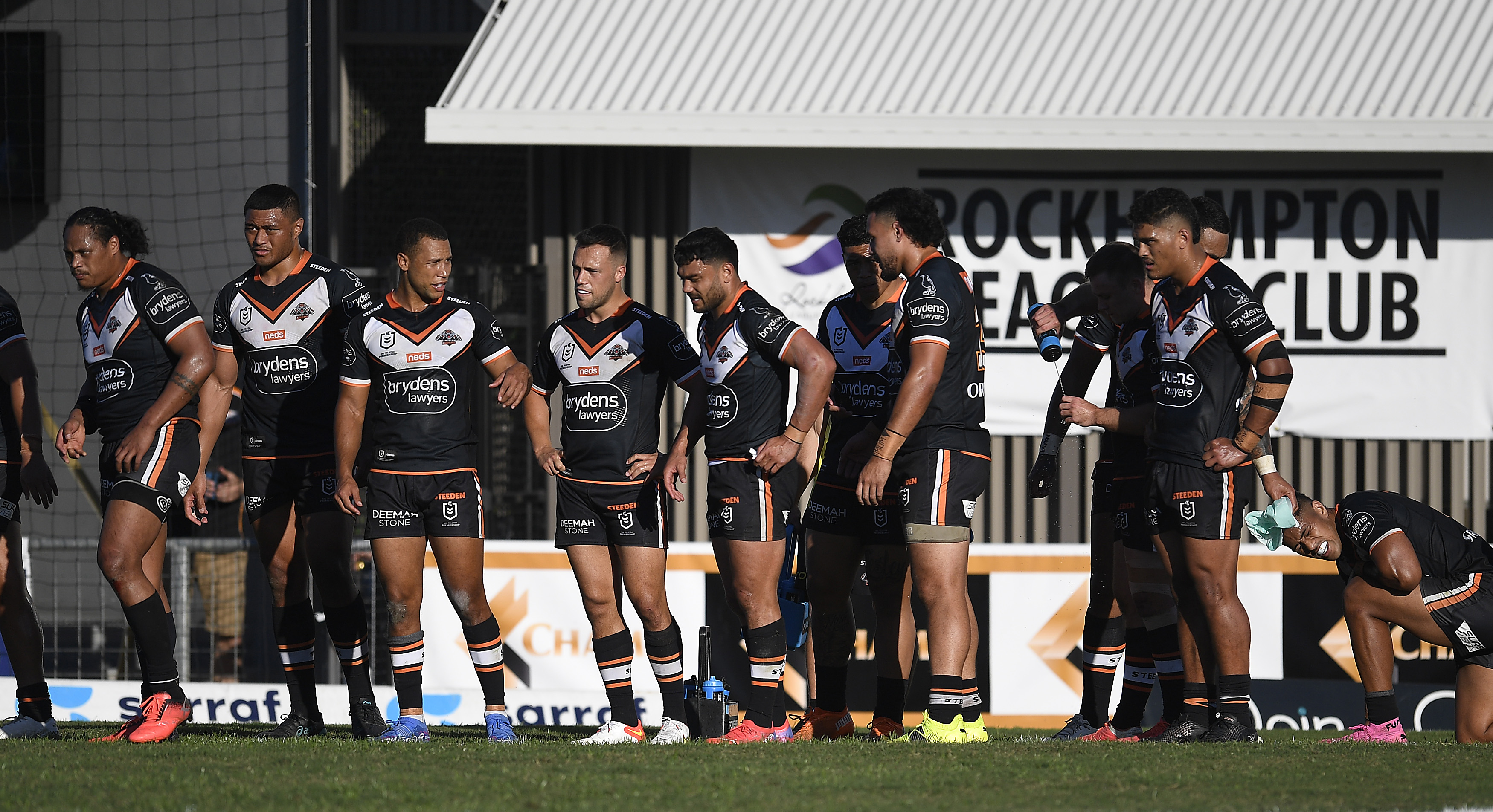 The Tigers look on after a Sharks try.