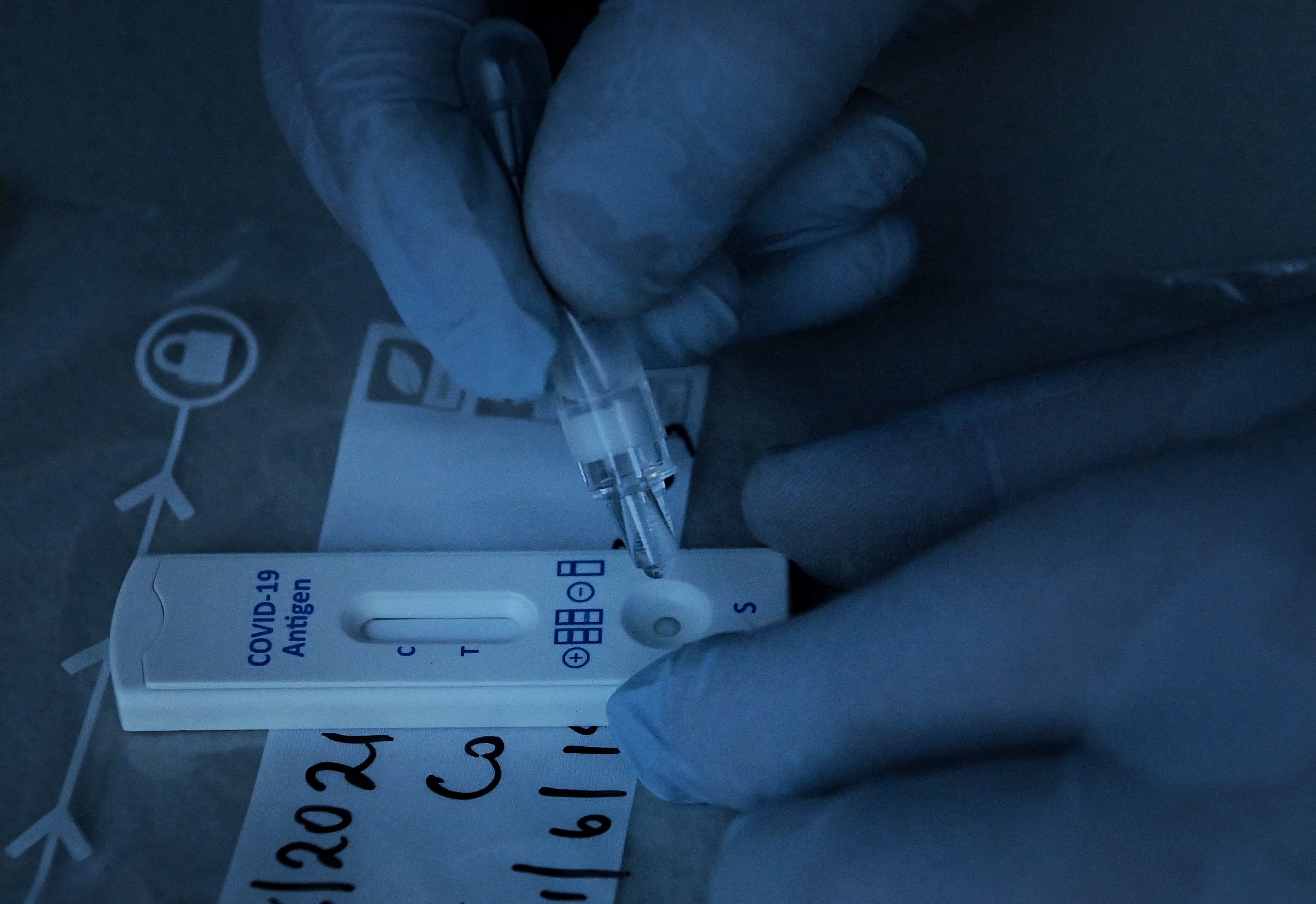 Dr Jeremy Cumpston conducts a COVID-19 rapid antigen test of construction workers at Mirvac Constructions Green Square site 15 in Zetland before they can start work. Zetland, NSW. 11th August, 2021. Photo: Kate Geraghty