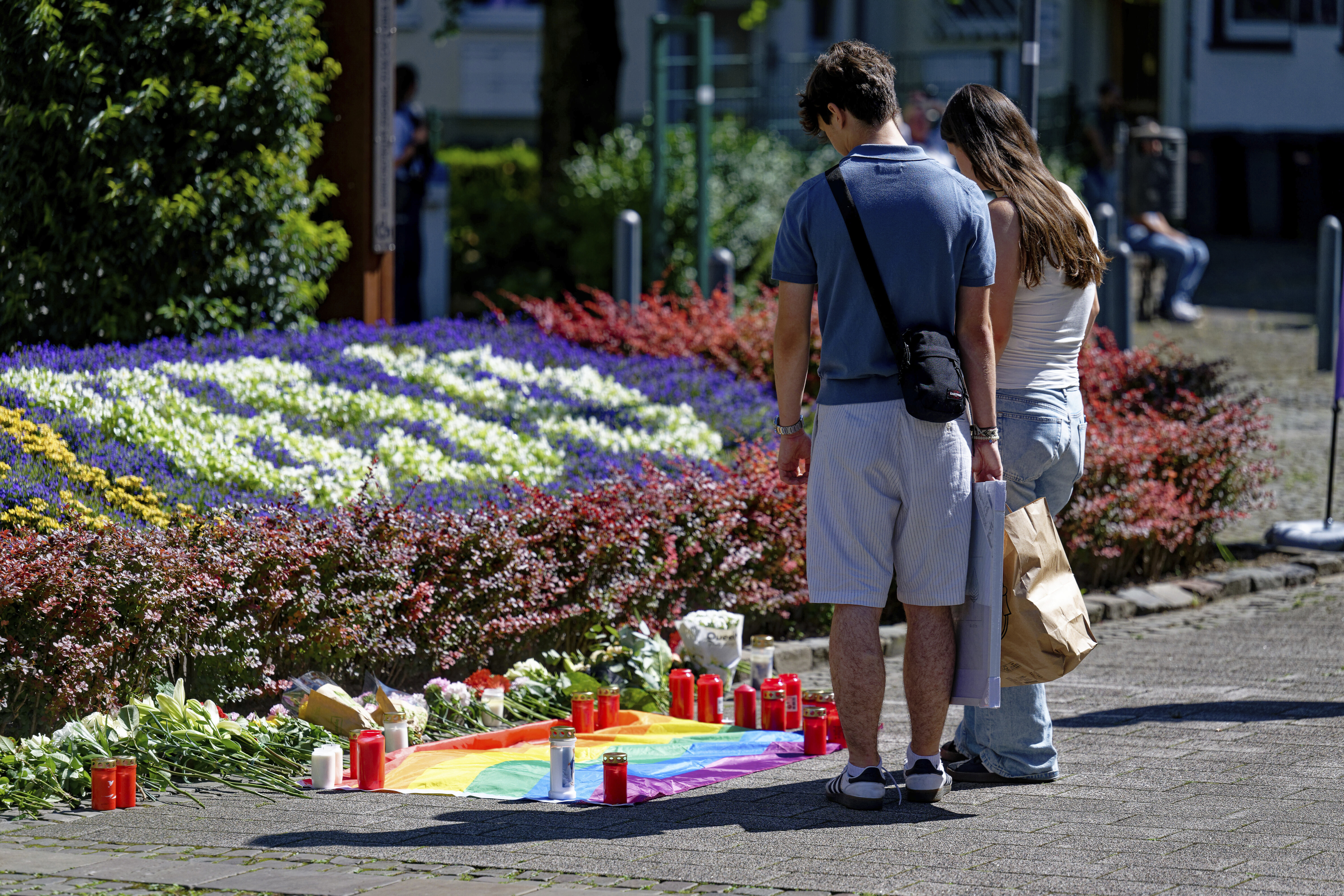 People lay flowers near the scene of a knife attack in Solingen city center, Germany