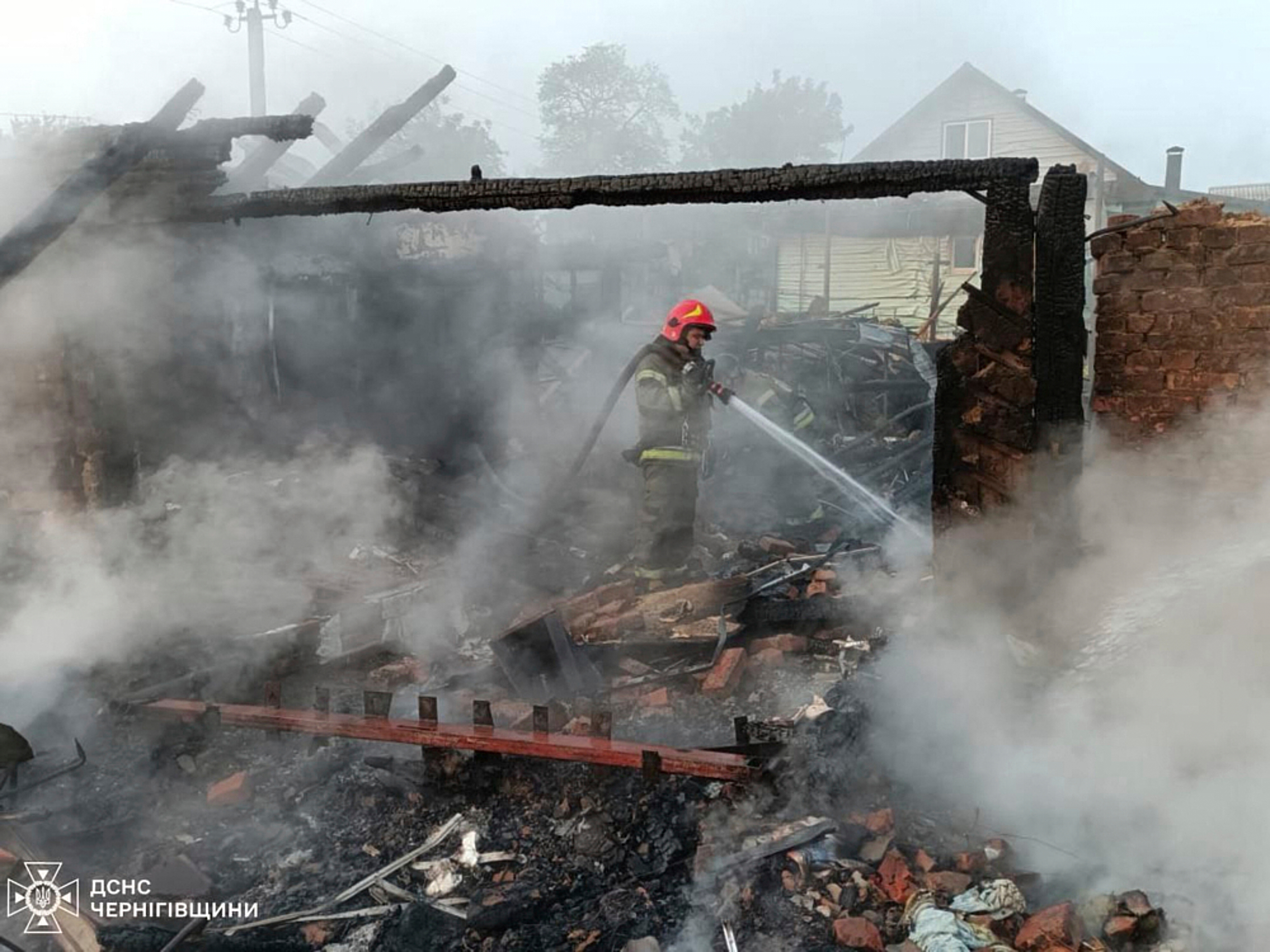 In this photo provided by the Ukrainian Emergency Service, firefighters put out the fire following Russia's drone attack in the Pryluky, Chernihiv region, Ukraine, Thursday, June 5, 2025. (Ukrainian Emergency Service via AP)