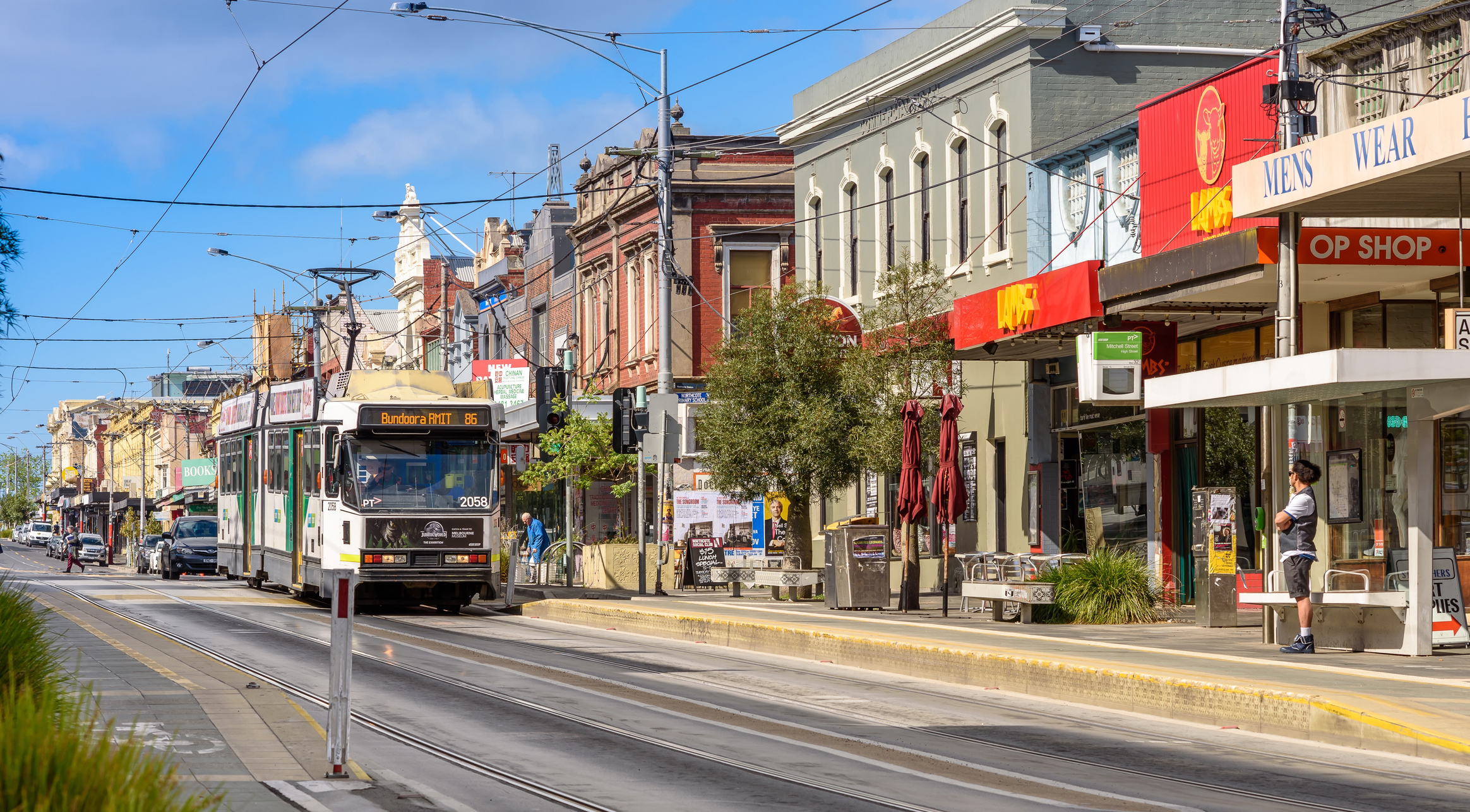 NORTHCOTE, VICTORIA/AUSTRALIA November 9: A unidentified man waits for the Number 86 tram on High Street in Northcote, Melbourne  on November 9, 2016.
