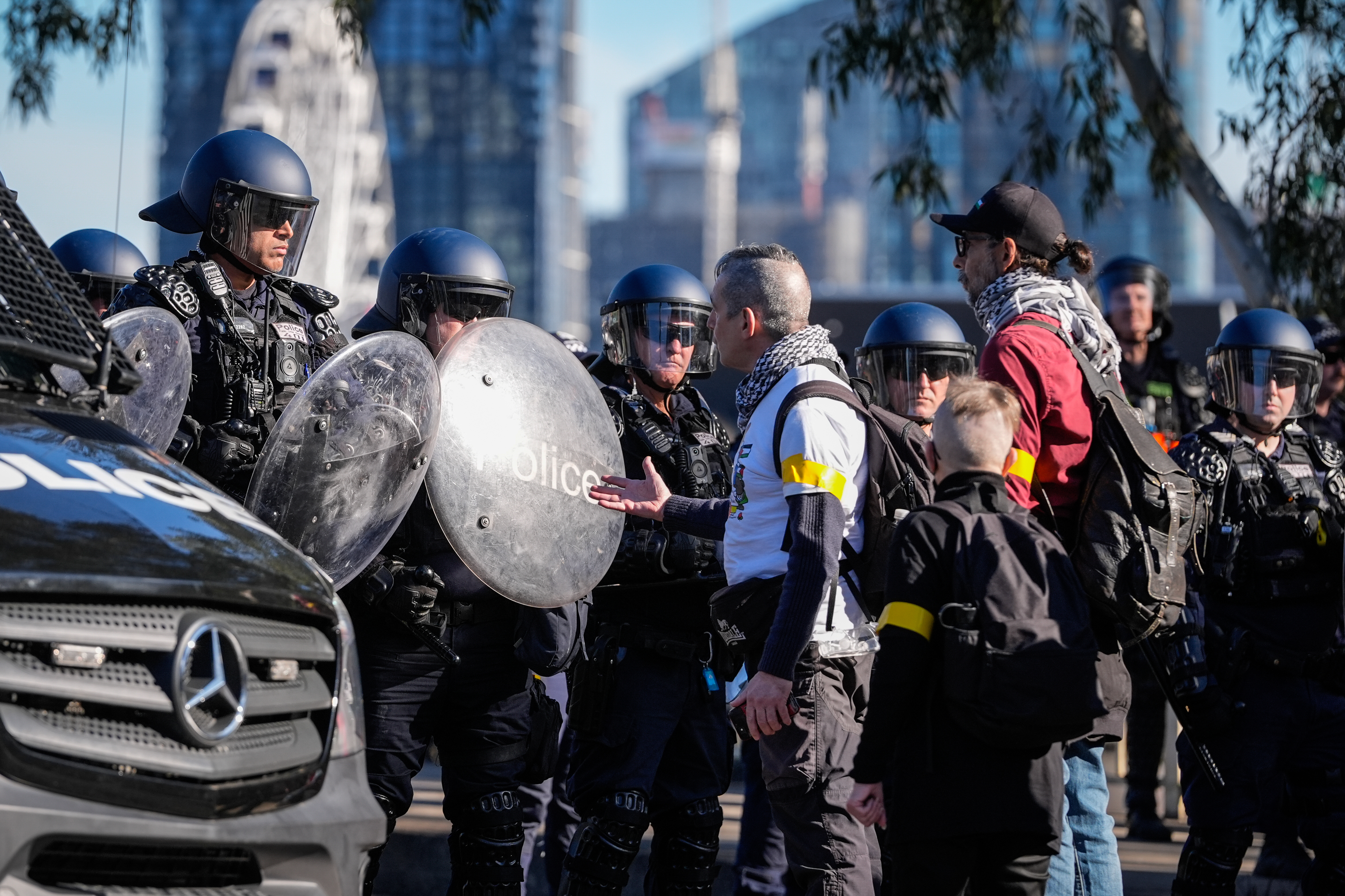 MELBOURNE, AUSTRALIA - AUGUST 03: A protester speaks to riot police as people march during a pro-Palestinian rally on August 03, 2025 in Melbourne, Australia. Protesters in Sydney and Melbourne joined marches and actions globally, as pressure mounts on the Israeli government over a devastating humanitarian crisis unfolding as its war against Hamas continues. (Photo by Asanka Ratnayake/Getty Images)