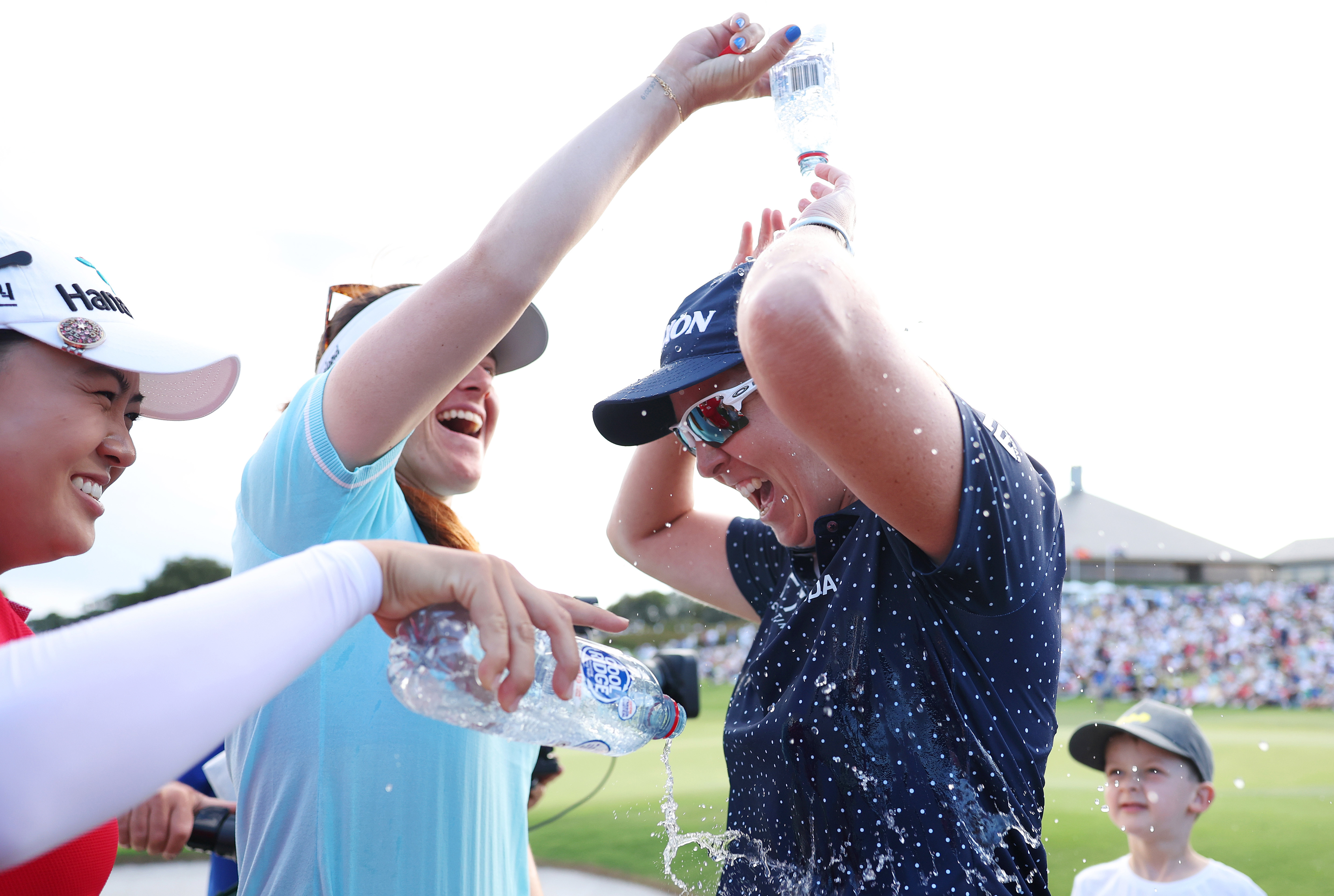 Ashleigh Buhai of South Africa is showered by Minjee Lee and Hannah Green of Australia.