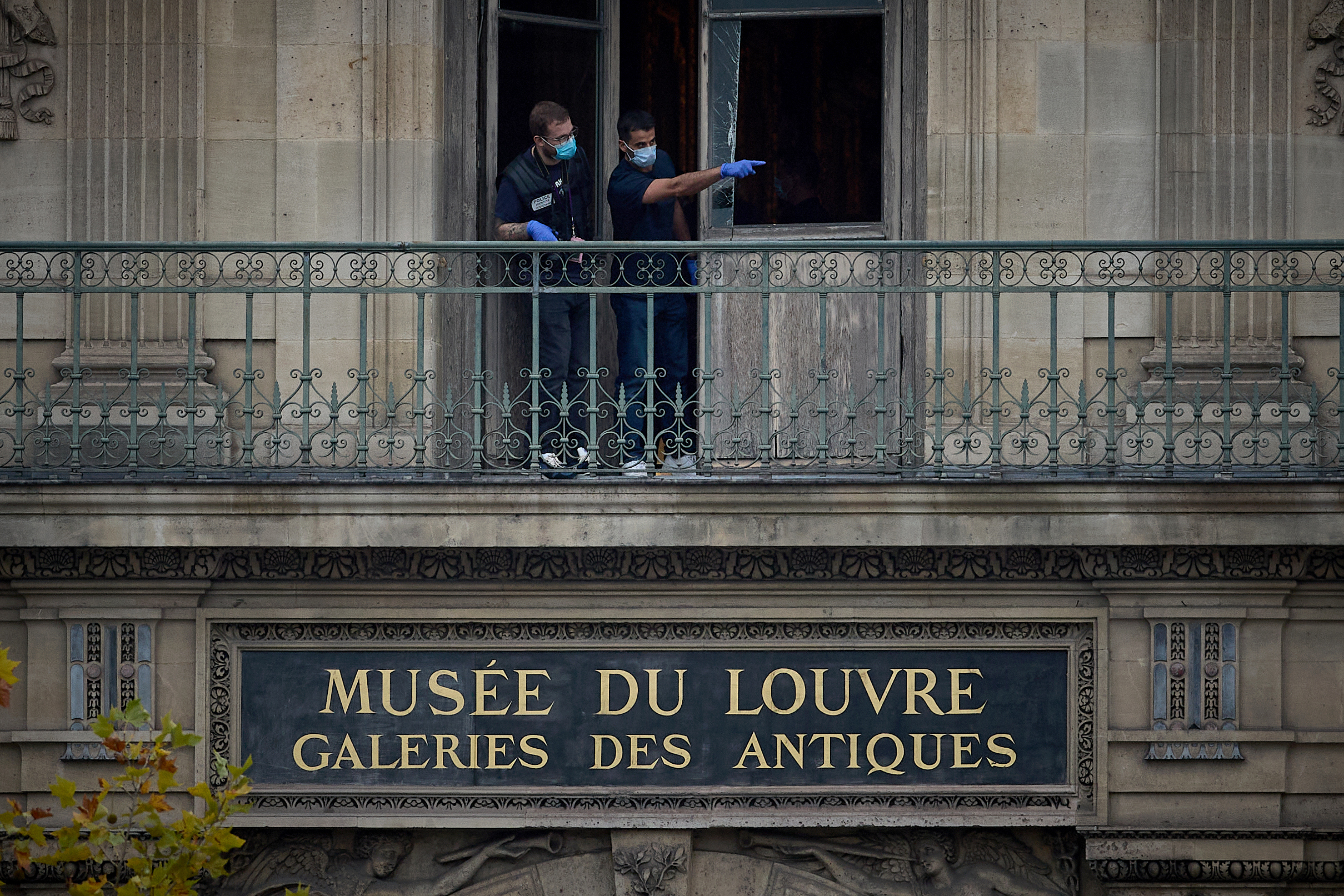 French Crime Scene Officers gesture as they examine the cut window and balcony of a gallery at the Louvre Museum the scene of a robbery at the world famous museum on October 19, 2025 in Paris, France.