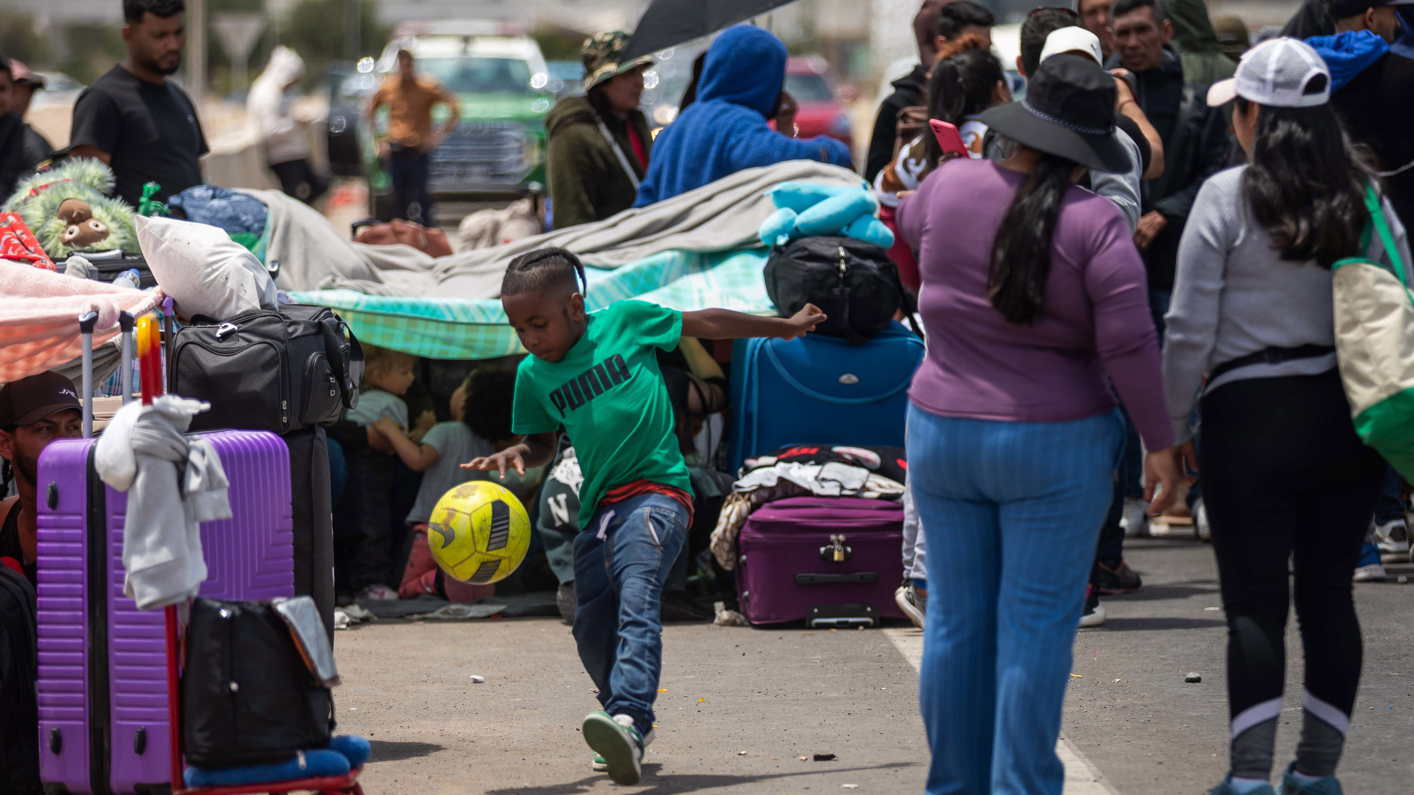 Migrants, mostly from Venezuela, wait to cross into Peru at the Chacalluta border crossing point in Arica, Chile.