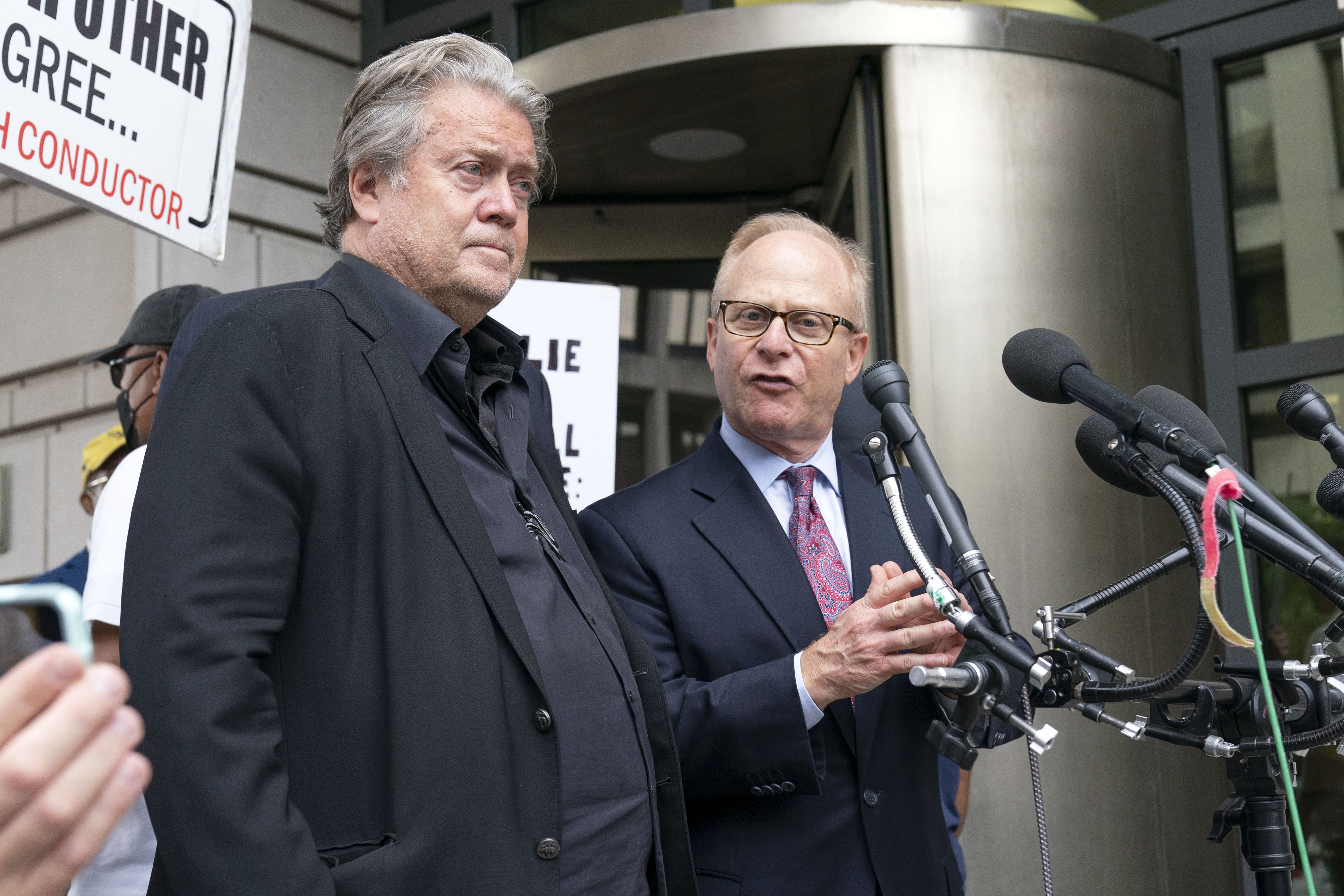 Steve Bannon accompanied by his attorney David Schoen, speaks to the media as he departs the federal court in Washington, Thursday, July 21, 2022. Bannon was brought to trial on a pair of federal charges for criminal contempt of Congress after refusing to cooperate with the House committee investigating the U.S. Capitol insurrection on Jan. 6, 2021. (AP Photo/Jose Luis Magana)