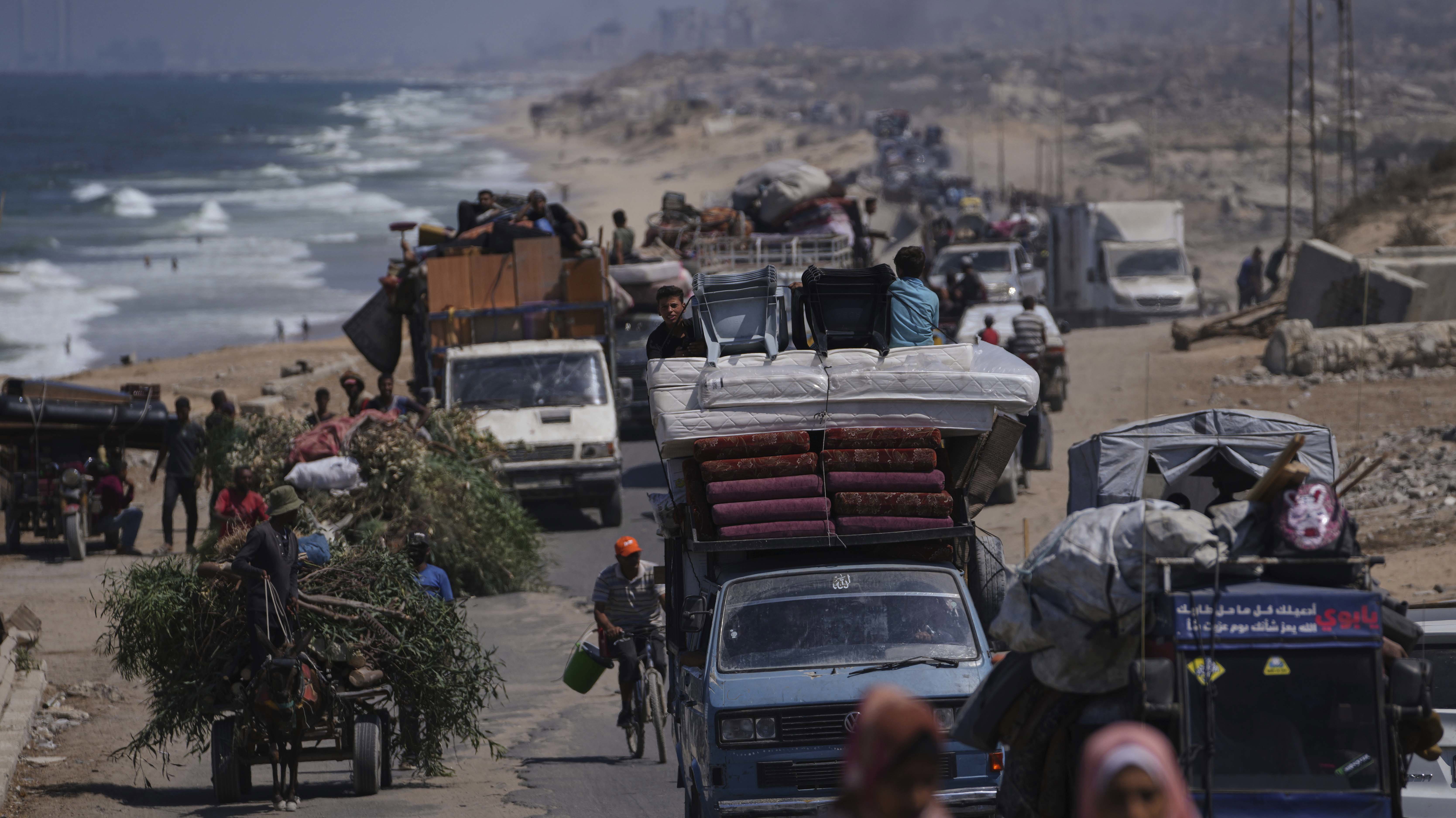 Displaced Palestinians fleeing northern Gaza carry their belongings along the coastal road toward southern Gaza, Tuesday, Sept. 9, 2025, after the Israeli army issued evacuation orders from Gaza City. (AP Photo/Jehad Alshrafi)