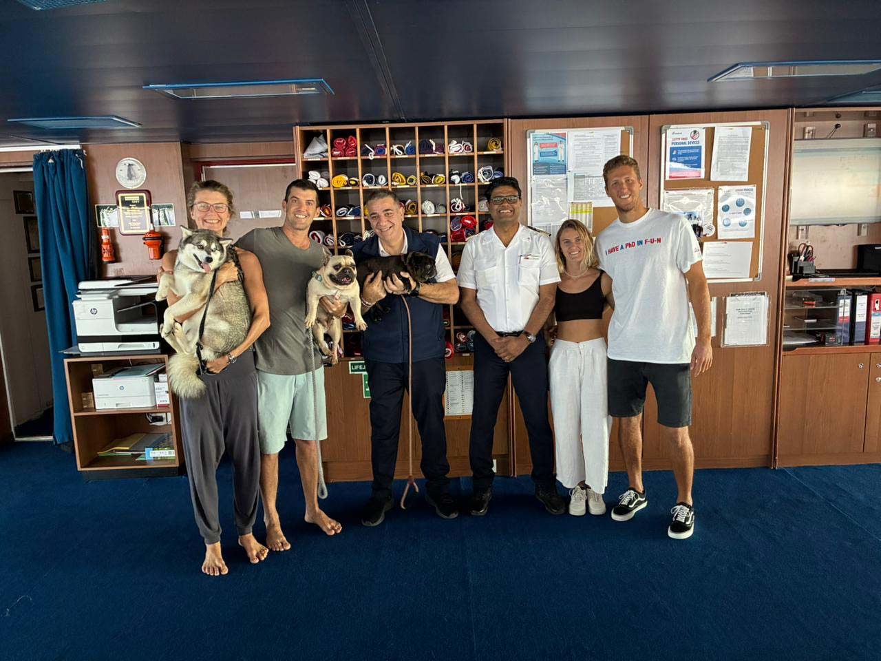 A cruise ship has rescued four people stranded on a disabled boat off the coast of New Caledonia.Carnival Splendor plucked the sailors and their three dogs from the catamaran in the South Pacific on Thursday.