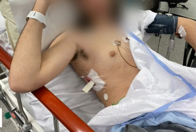 The 15-year-old boy was hospitalised with a stab wound to the torso after a man allegedly broke into the Gold Coast unit in Varsity Lakes about 1am armed with a golf club and knife, according to police.