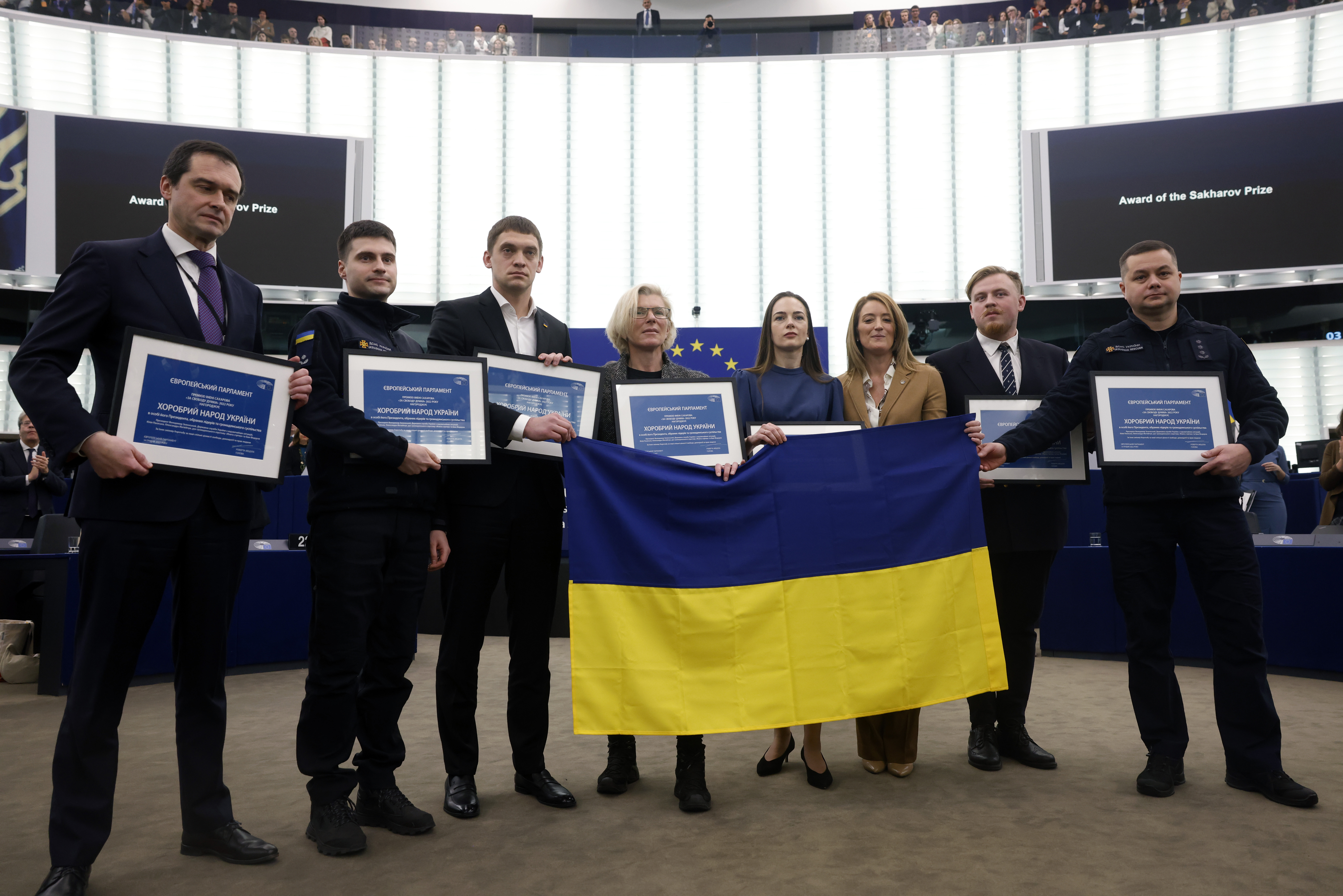 (L-R), Mission of Ukraine to the EU, State Emergency Services of Ukraine, Mayor of Ukrainian city of Melitopol, Founder of the medical evacuation unit Angels of Taira, Nobel Peace Prize winner Oleksandra Matviichuk, Spokesperson of the Yellow Ribbon Civil Resistance Movement and Director of State Emergency Services of Ukraine pose with European Parliament President Roberta Metsola (third right) after receiving the Sakharov Prize