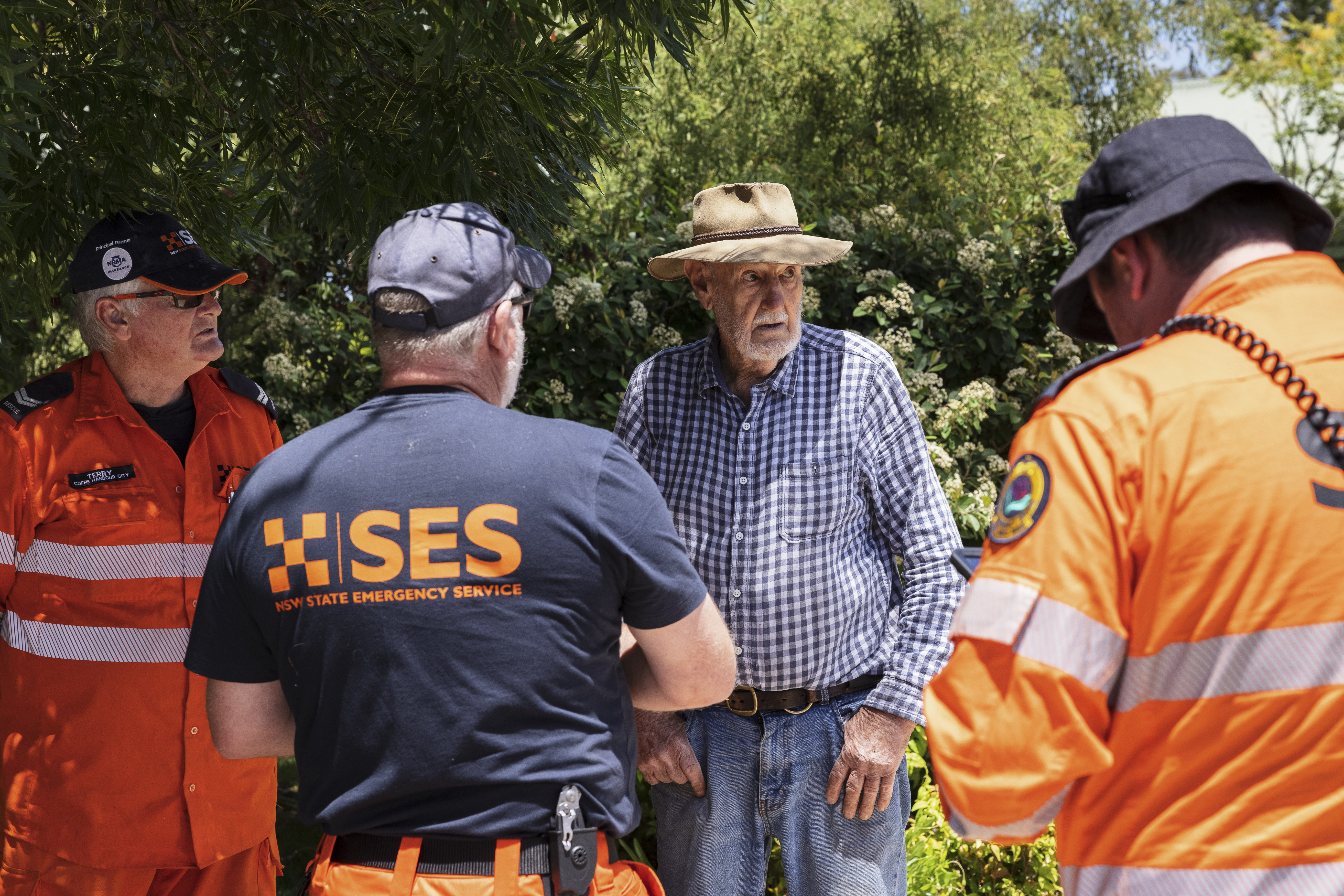 State Emergency Service (SES) workers speak to local resident Don Bray.