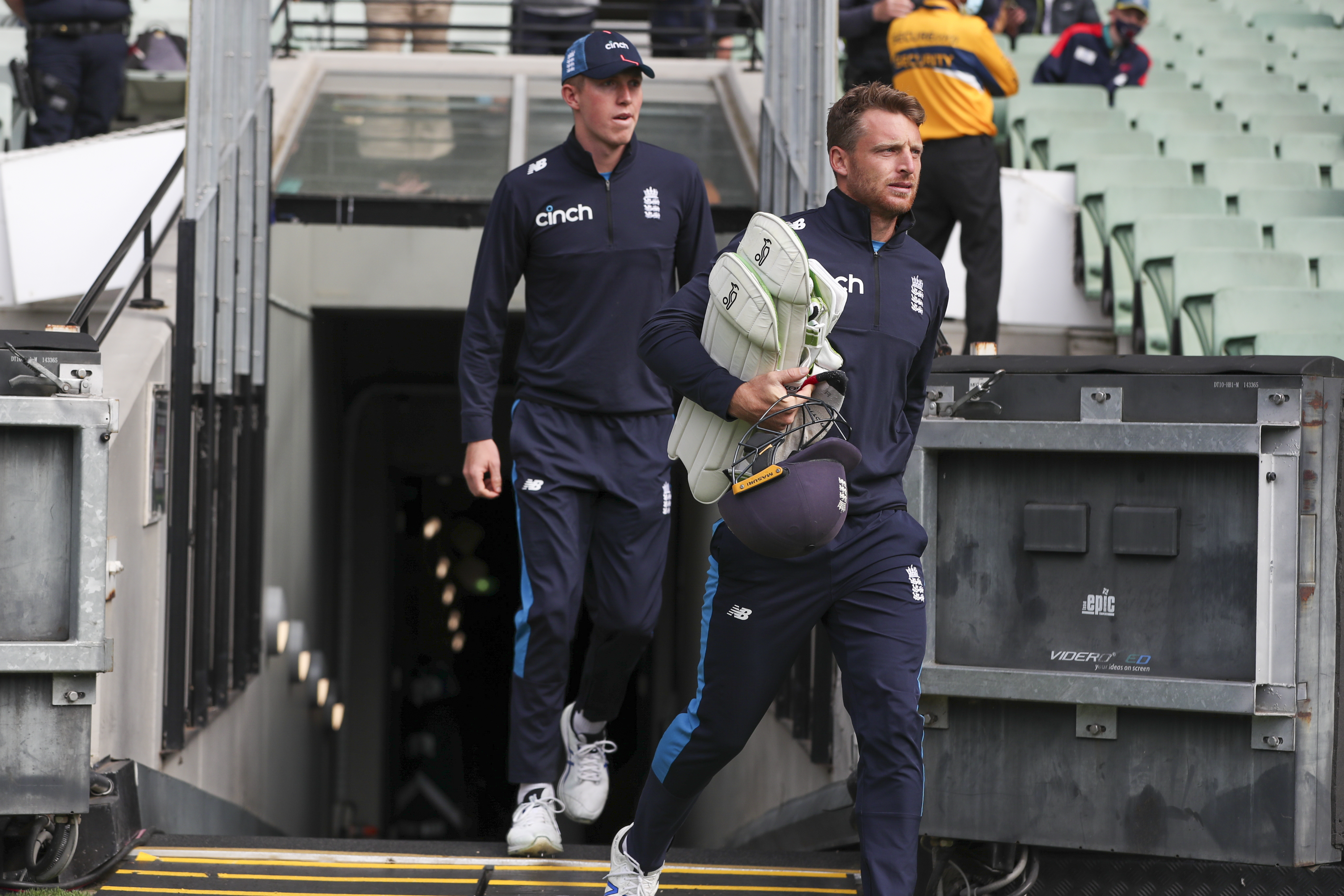 England's Jos Buttler, right, and Zak Crawley arrive at the Melbourne Cricket Ground.
