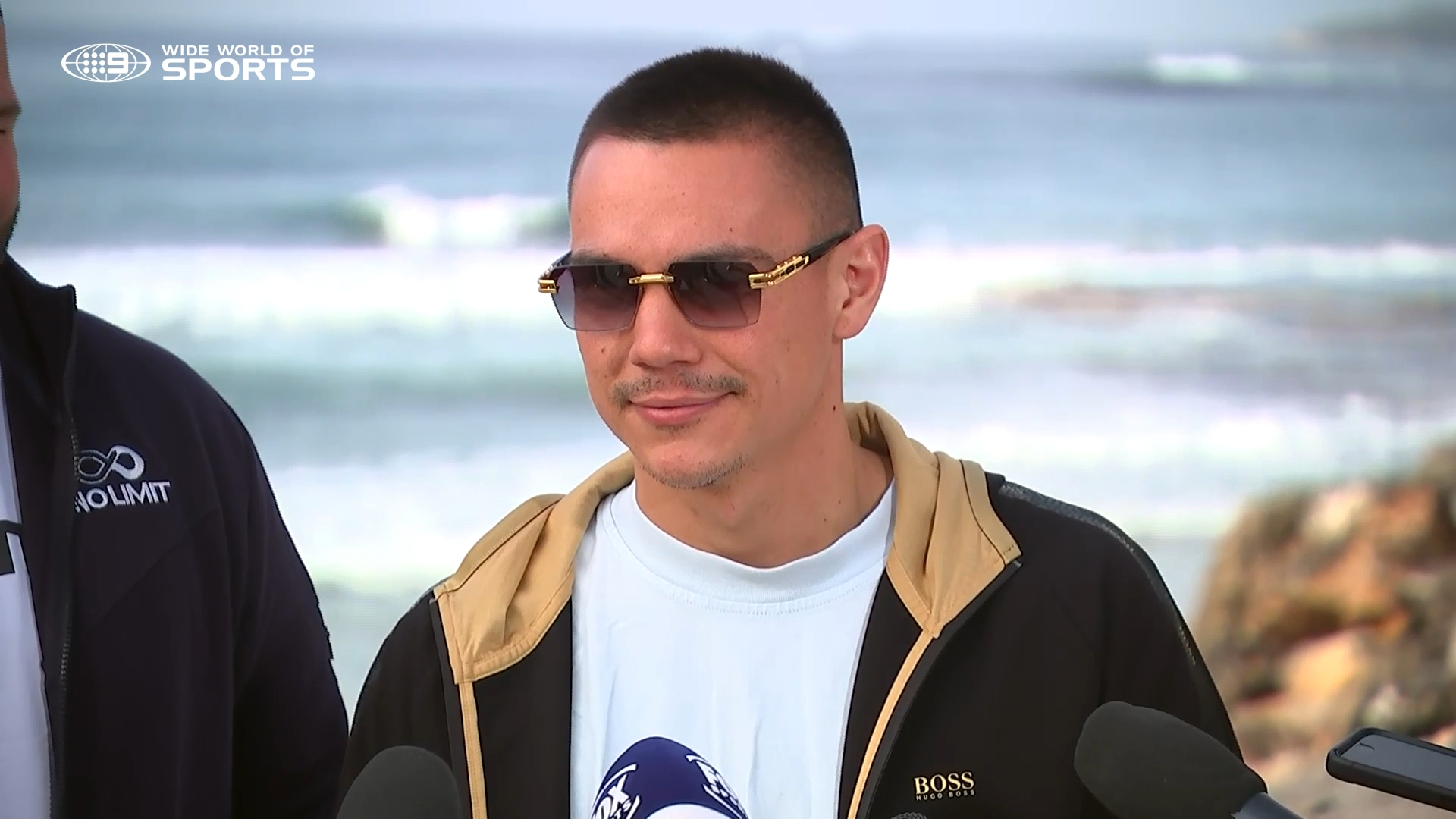 Aussie boxer Tim Tszyu fronts media after being bitten by a dog.