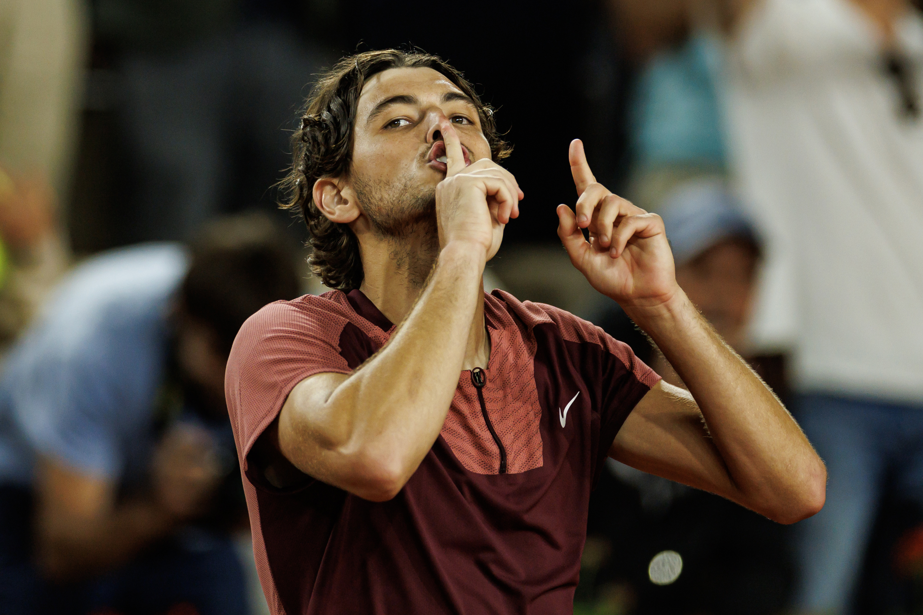 Taylor Fritz of the United States  celebrates his victory over Arthur Rinderknech of France by shushing the crowd.