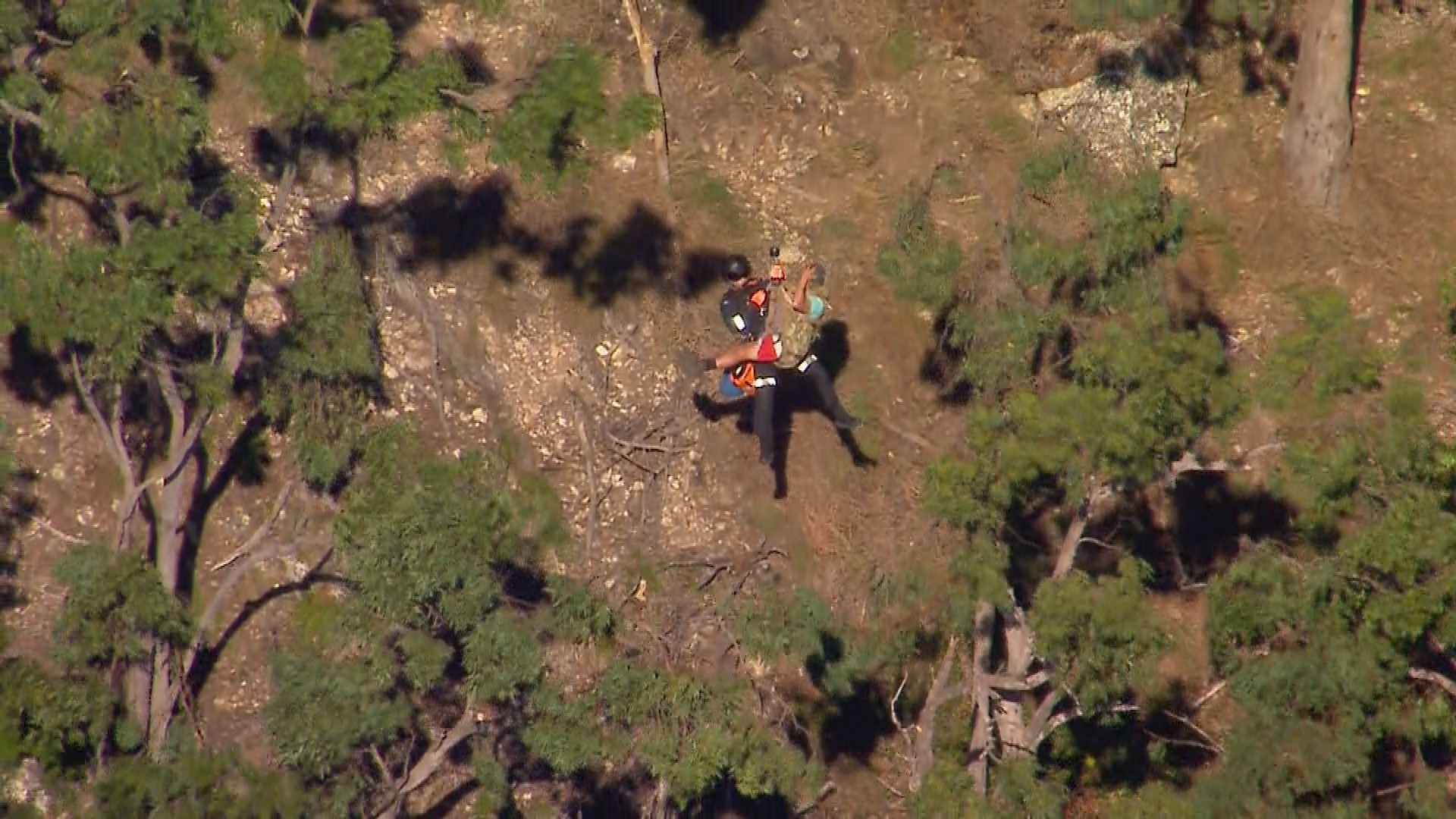 A major rescue operation is unfolding atop a mountain in Queensland after four people became trapped on a cliff.