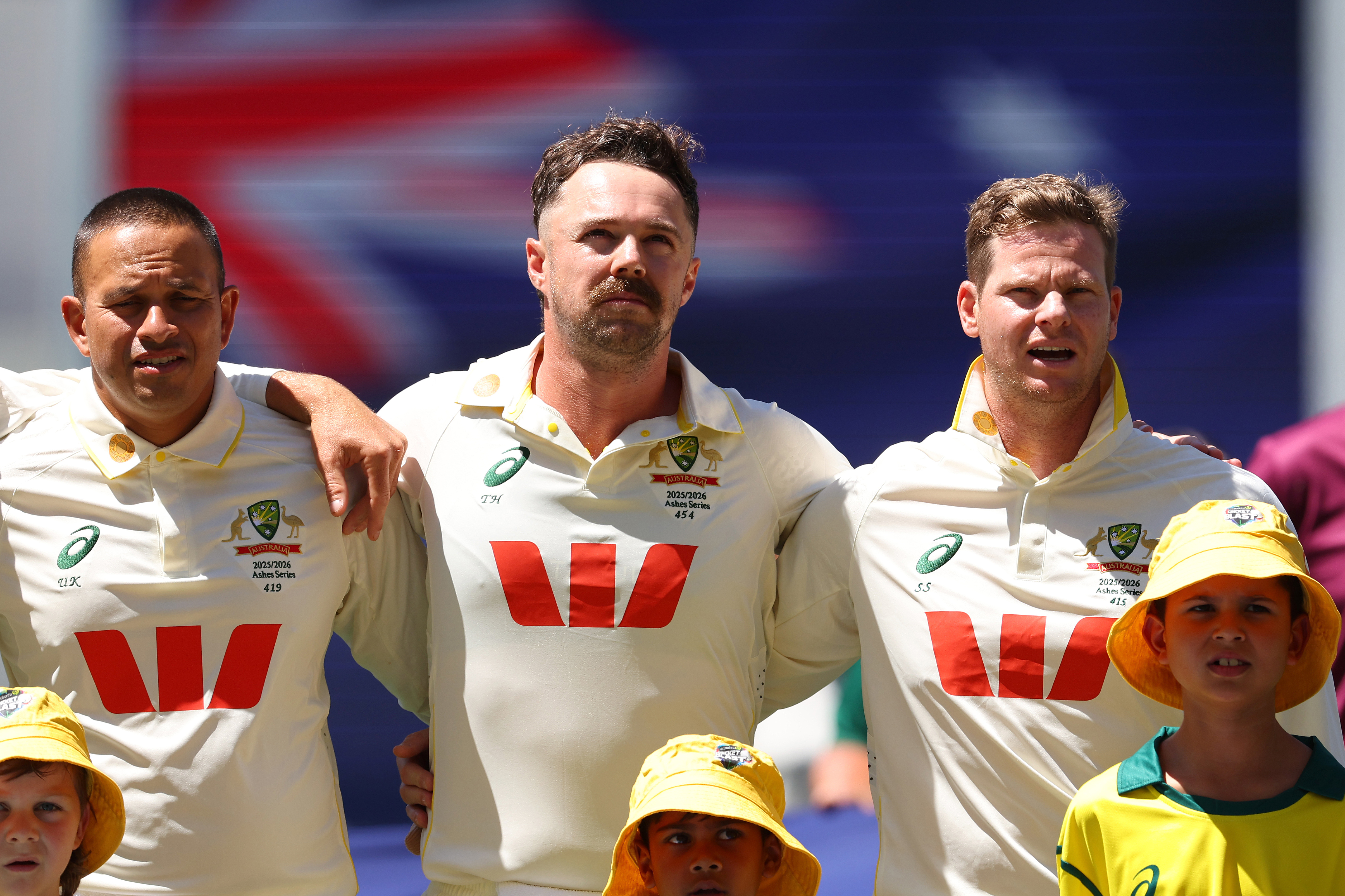 PERTH, AUSTRALIA - NOVEMBER 21: Usman Khawaja, Travis Head and Steve Smith of Australia sing the national anthem during day one of the First 2025/26 Ashes Series Test Match between Australia and England at Perth Stadium on November 21, 2025 in Perth, Australia. (Photo by Paul Kane - CA/Cricket Australia via Getty Images)