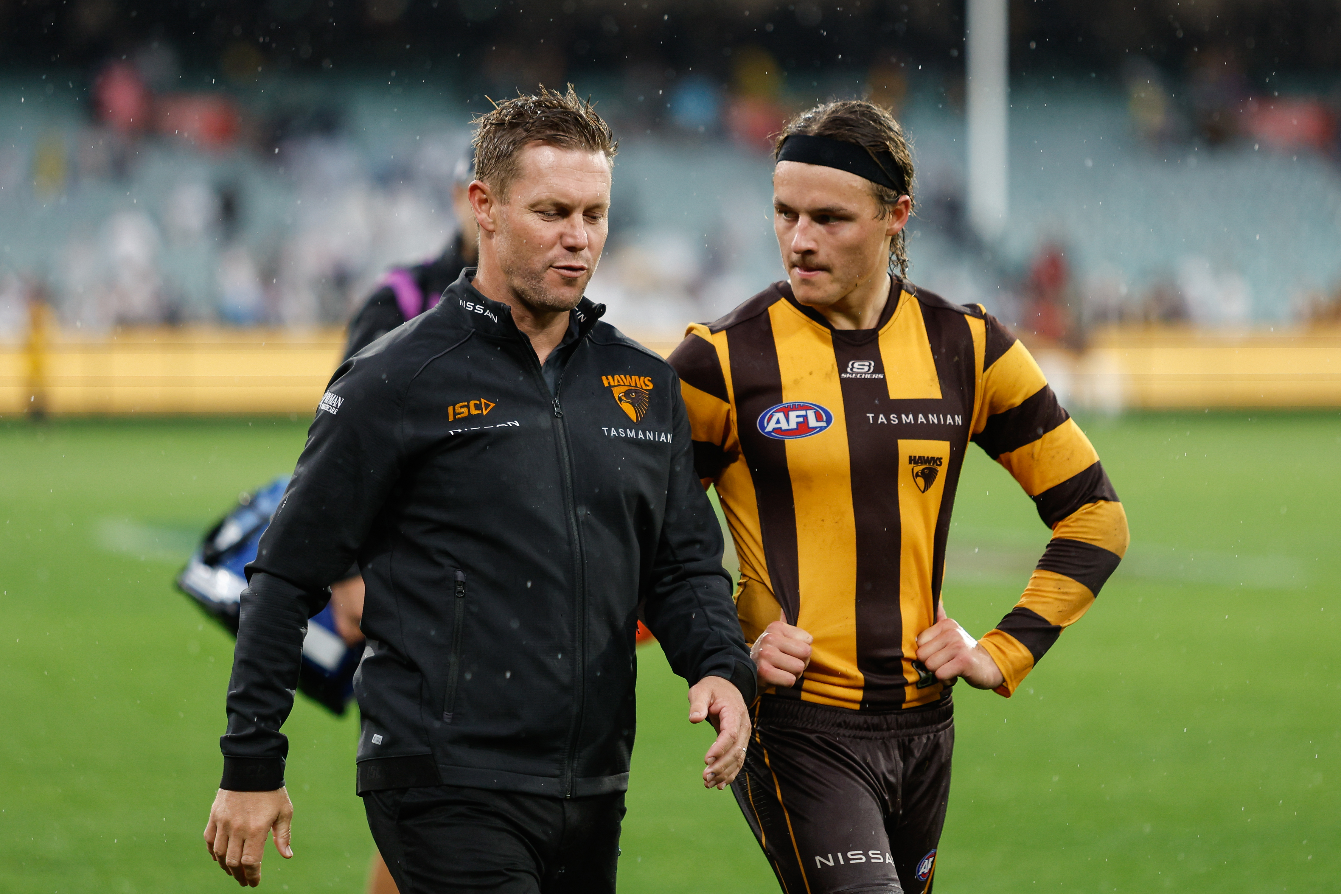 Sam Mitchell walks with Jack Ginnivan.