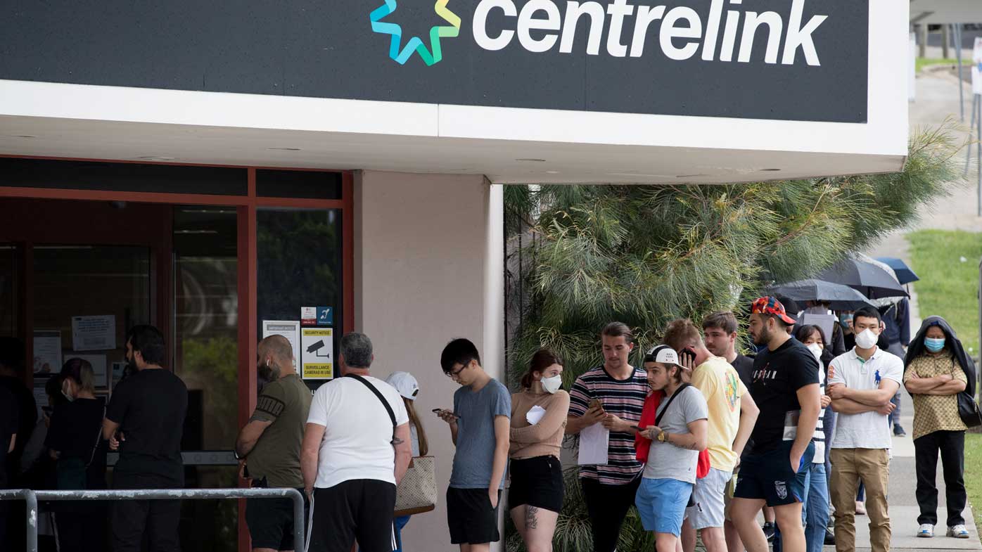 Newly unemployed Sydneysiders queue up outside a Centrelink in Rockdale.