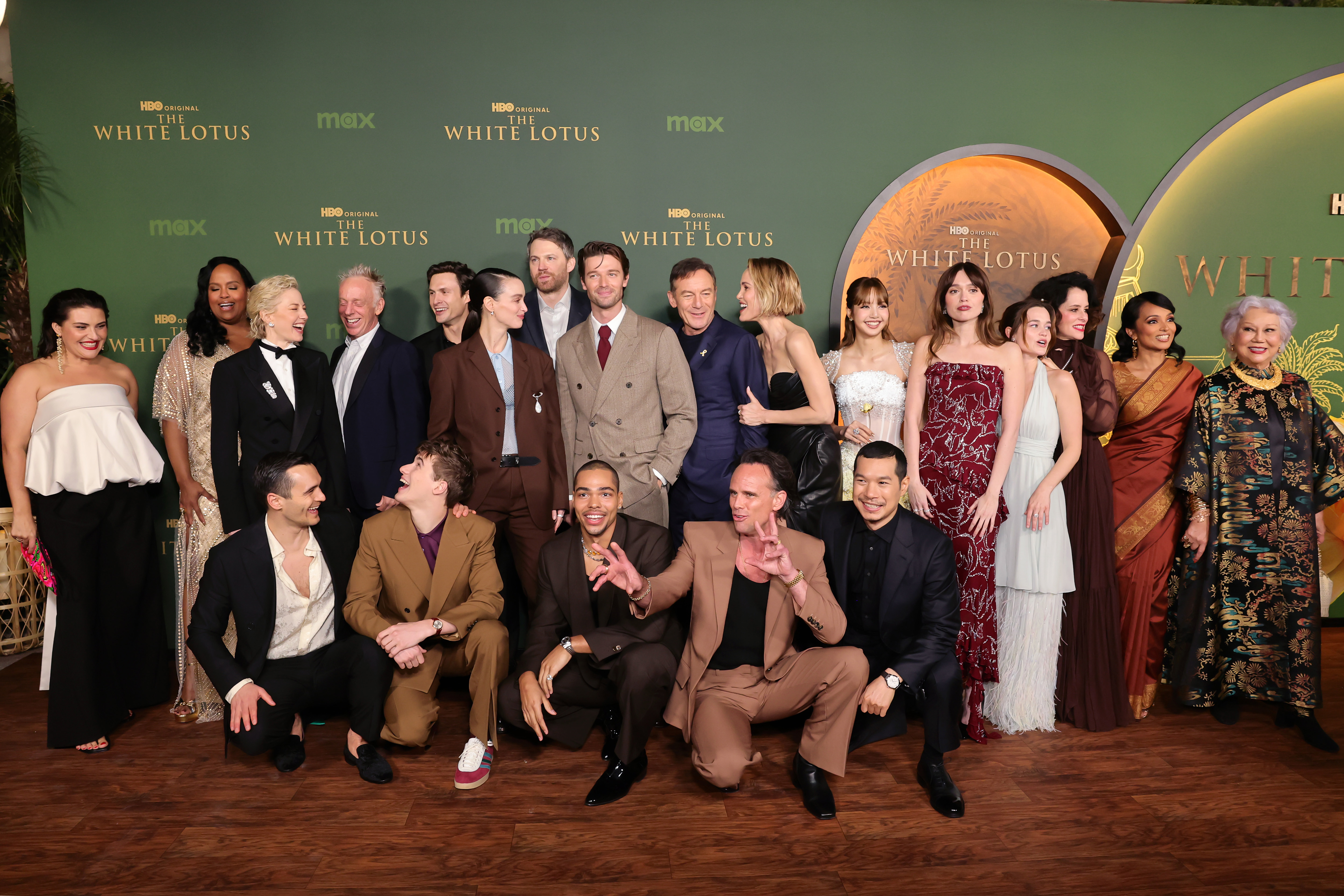 LOS ANGELES, CALIFORNIA - FEBRUARY 10: (L-R) Morgana O'Reilly, Natasha Rothwell, Julian Kostov, Carrie Coon, Mike White, Sam Nivola, Arnas Fedaraviius, Charlotte Le Bon, David Bernad, Nicholas Duvernay, Patrick Schwarzenegger, Jason Isaacs, Walton Goggins, Leslie Bibb, Tayme Thapthimthong, Lisa, Aimee Lou Wood, Sarah Catherine Hook, Parker Posey, Shalini Peiris and Lek Patravadi attend the Los Angeles Premiere of HBO Original Series "The White Lotus" Season 3 at Paramount Theatre on February 10,