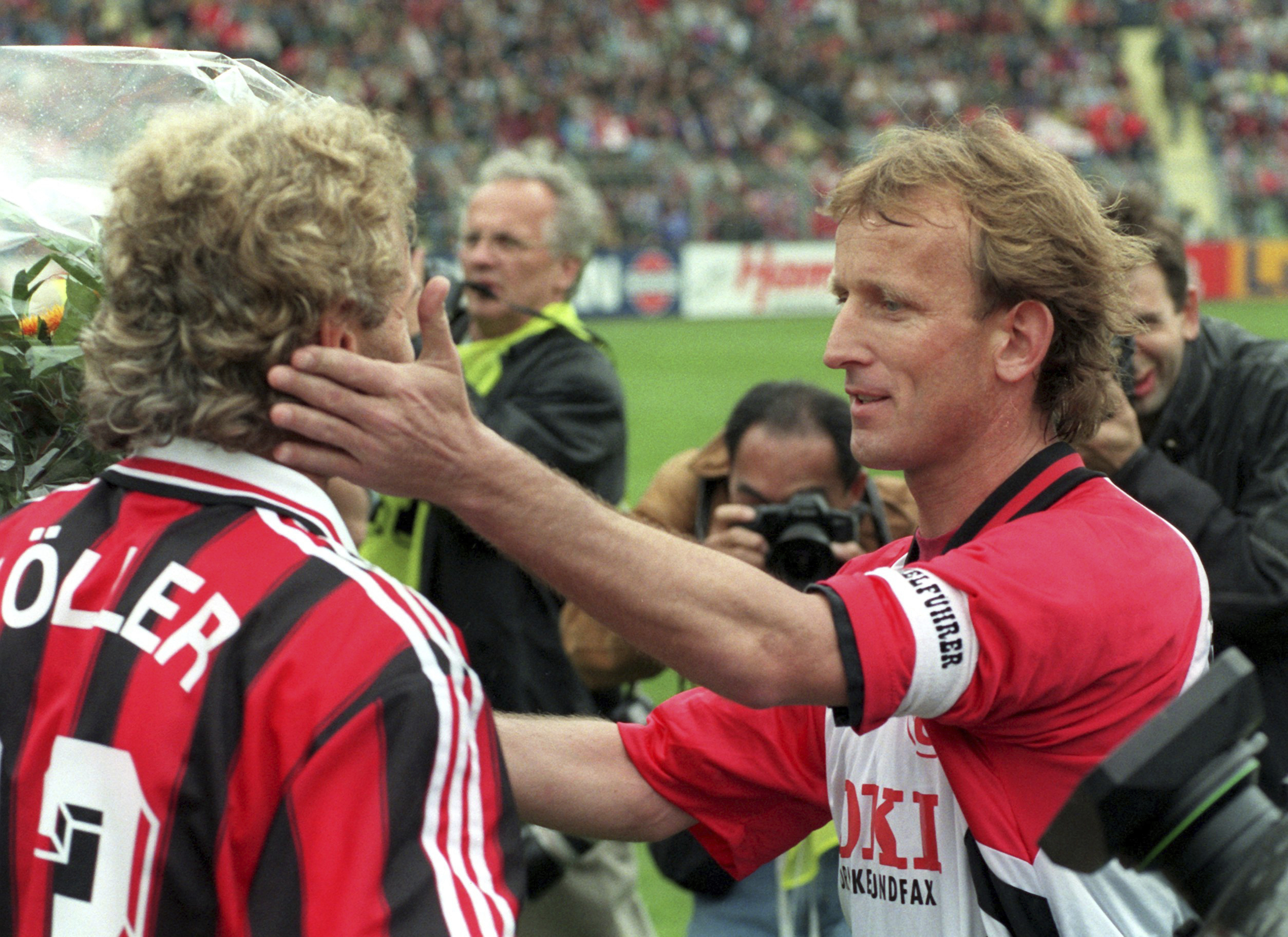 Andreas Brehme (right) and Leverkusen's Rudi Voeller in 1996.
