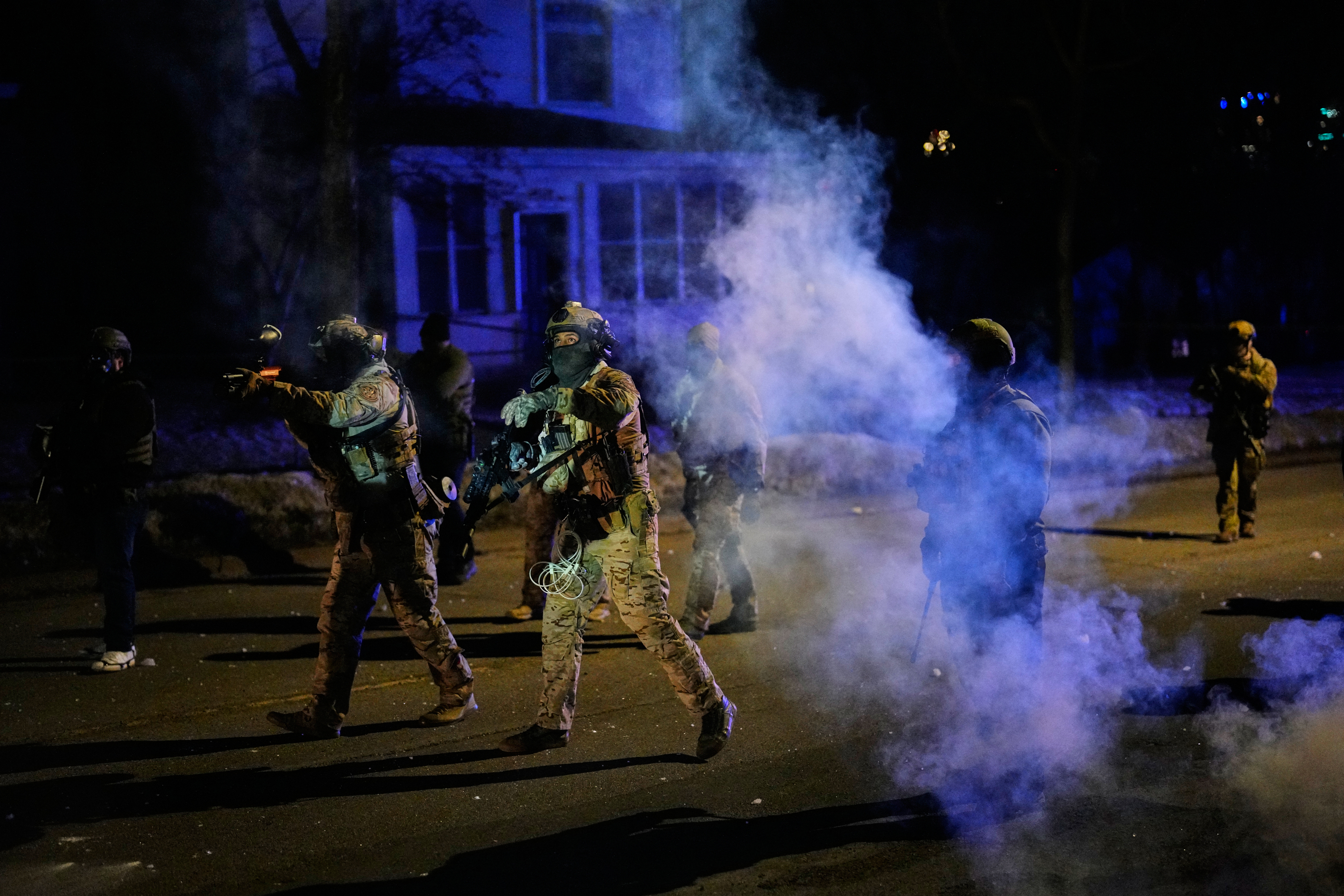 Federal immigration officers shoot pepper balls as tear gas is deployed at the scene of a reported shooting Wednesday, Jan. 14, 2026, in Minneapolis. (AP Photo/John Locher)