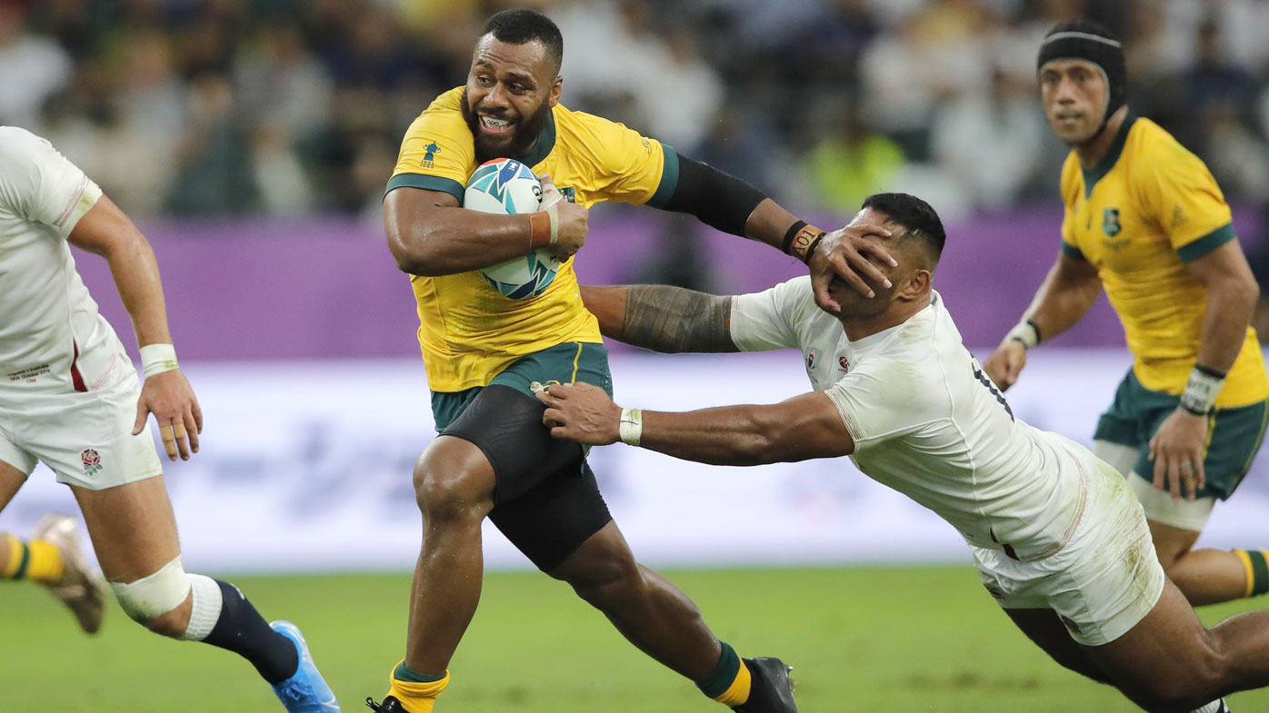 Australia's Samu Kerevi, left, fends off an England defender during the Rugby World Cup quarterfinal match