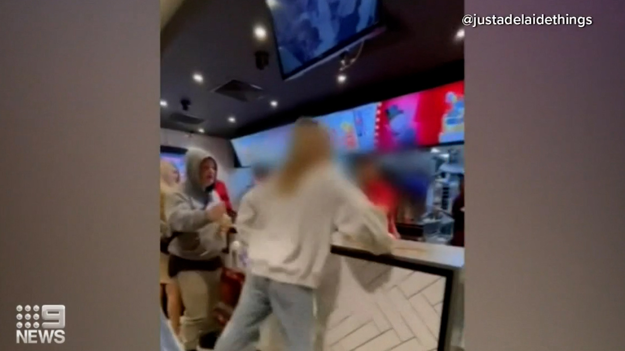 Shocking footage has emerged of a young woman lashing out and spitting at McDonalds staff in Adelaide.Police are now investigating the incident, which the Retail Workers' Union has labelled "vile and disgusting."