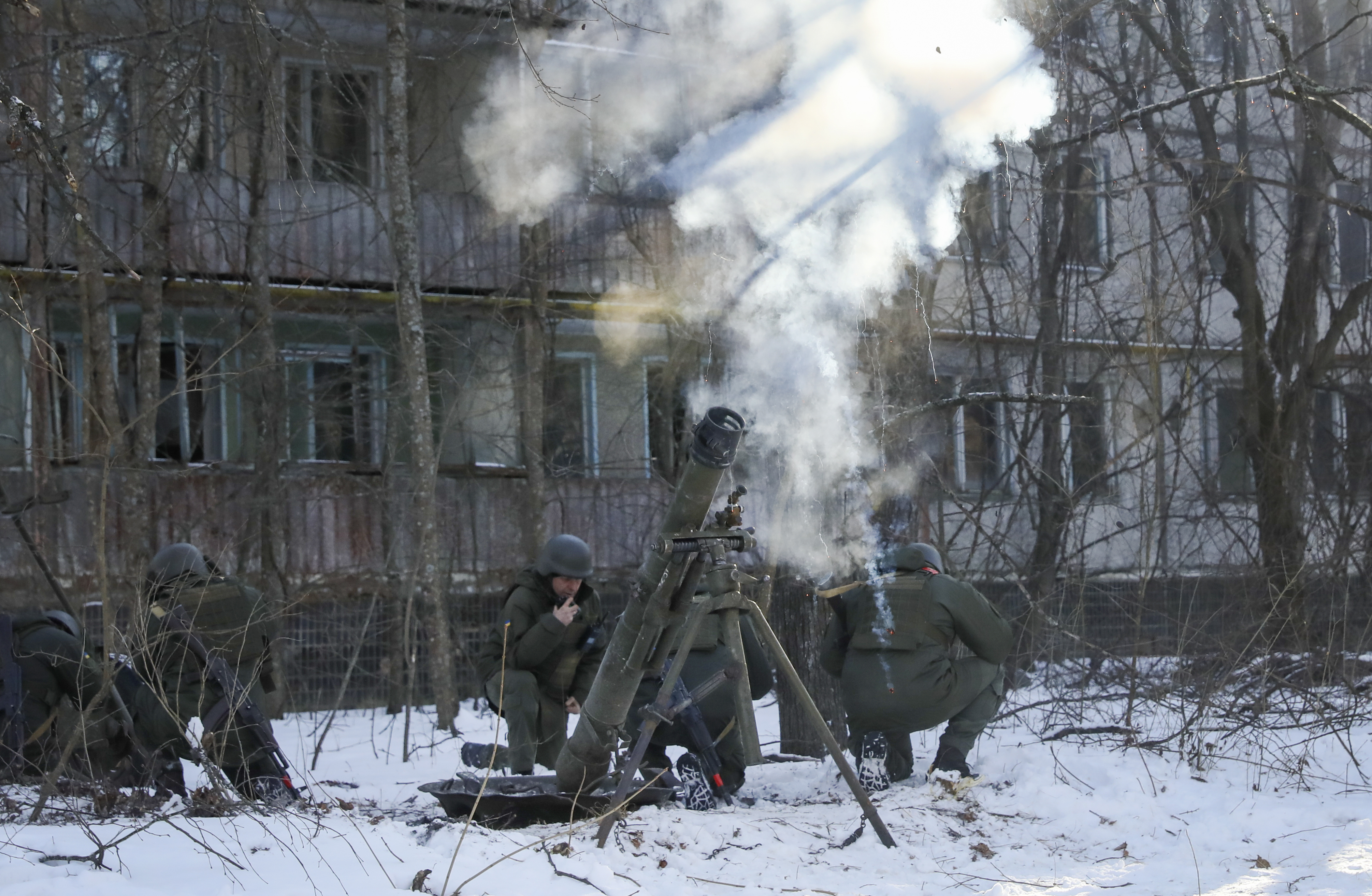 The National Guard soldiers take part in tactical exercises, which are conducted by the Ukrainian National Guard, Armed Forces, special operations units and simulate a crisis situation in an urban settlement, in the abandoned city of Pripyat near the Chernobyl Nuclear Power Plant, Ukraine, Friday, Feb. 4, 2022. (AP Photo/Mykola Tymchenko)