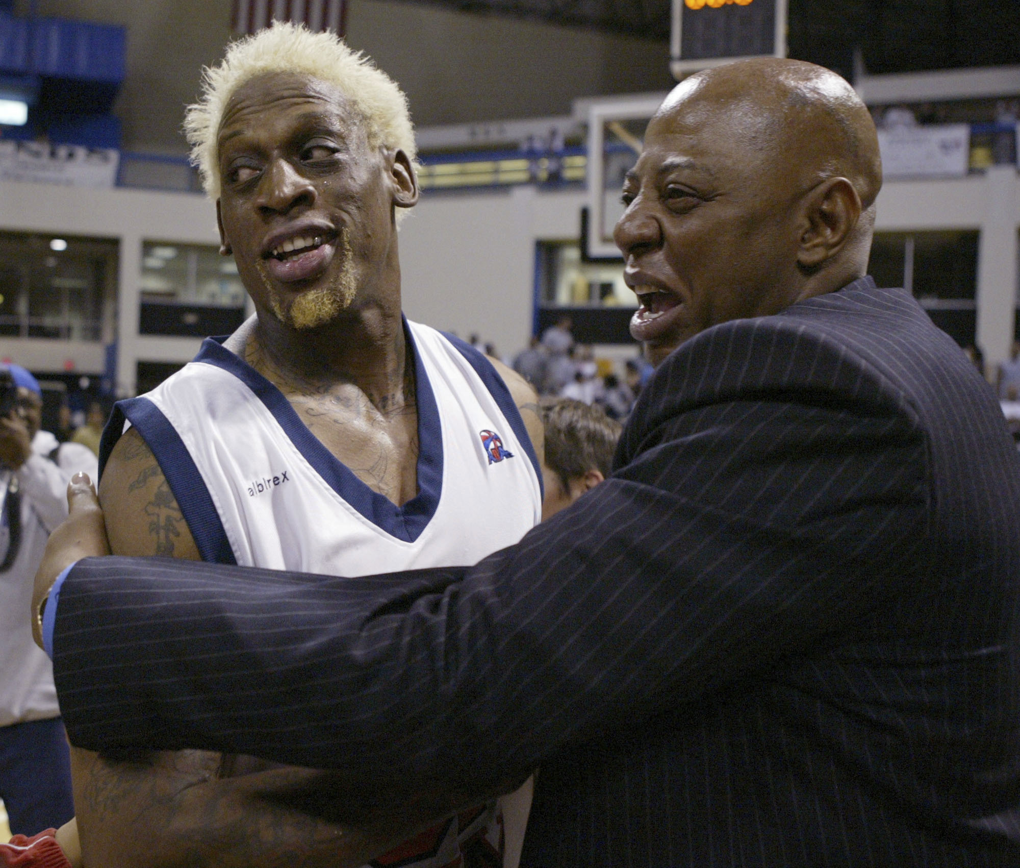 Dennis Rodman gets a hug from Earl Cureton.